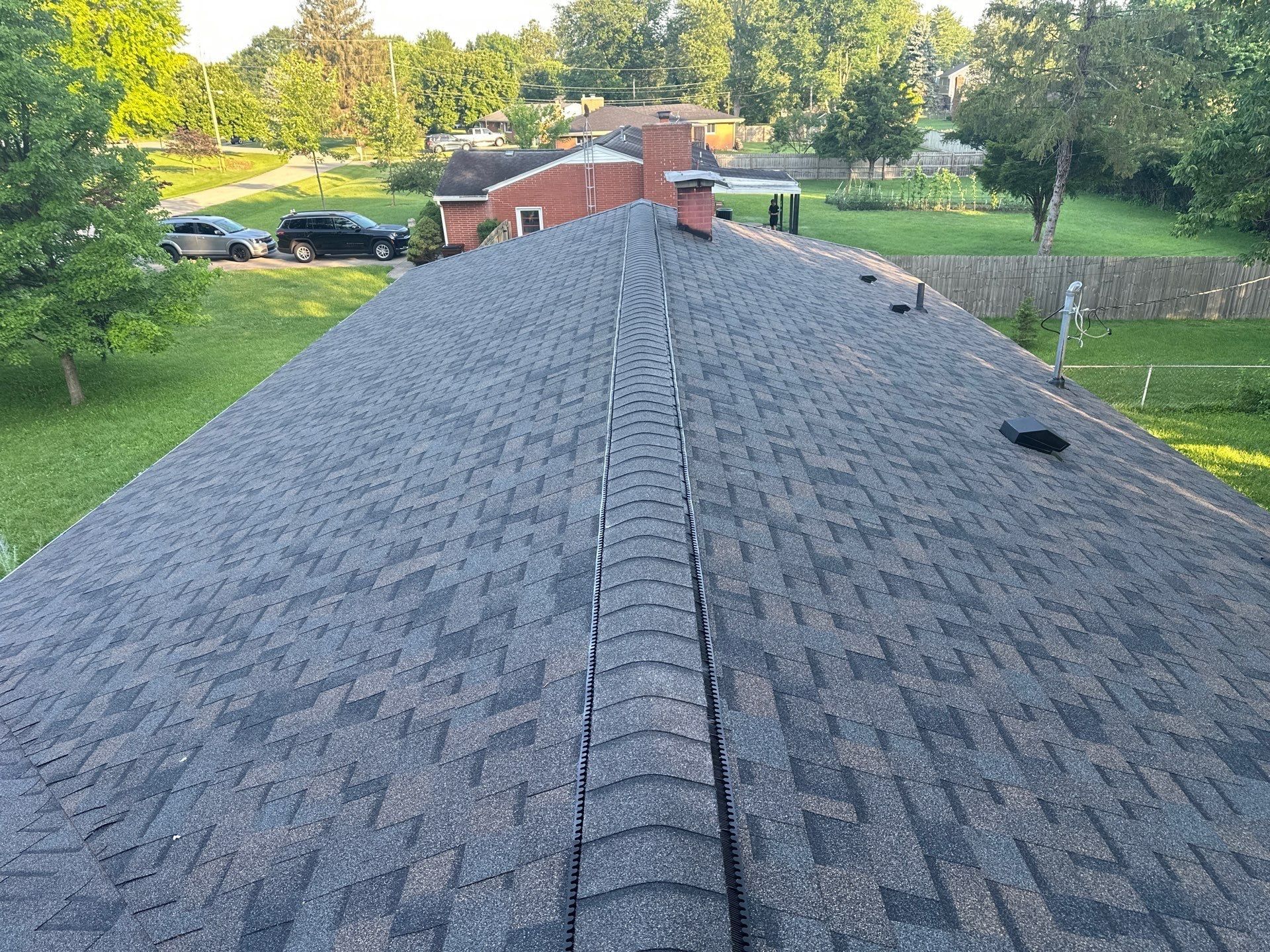 Finished main roof with a shingle capped ridge vent running its length, Beavercreek, Ohio.
