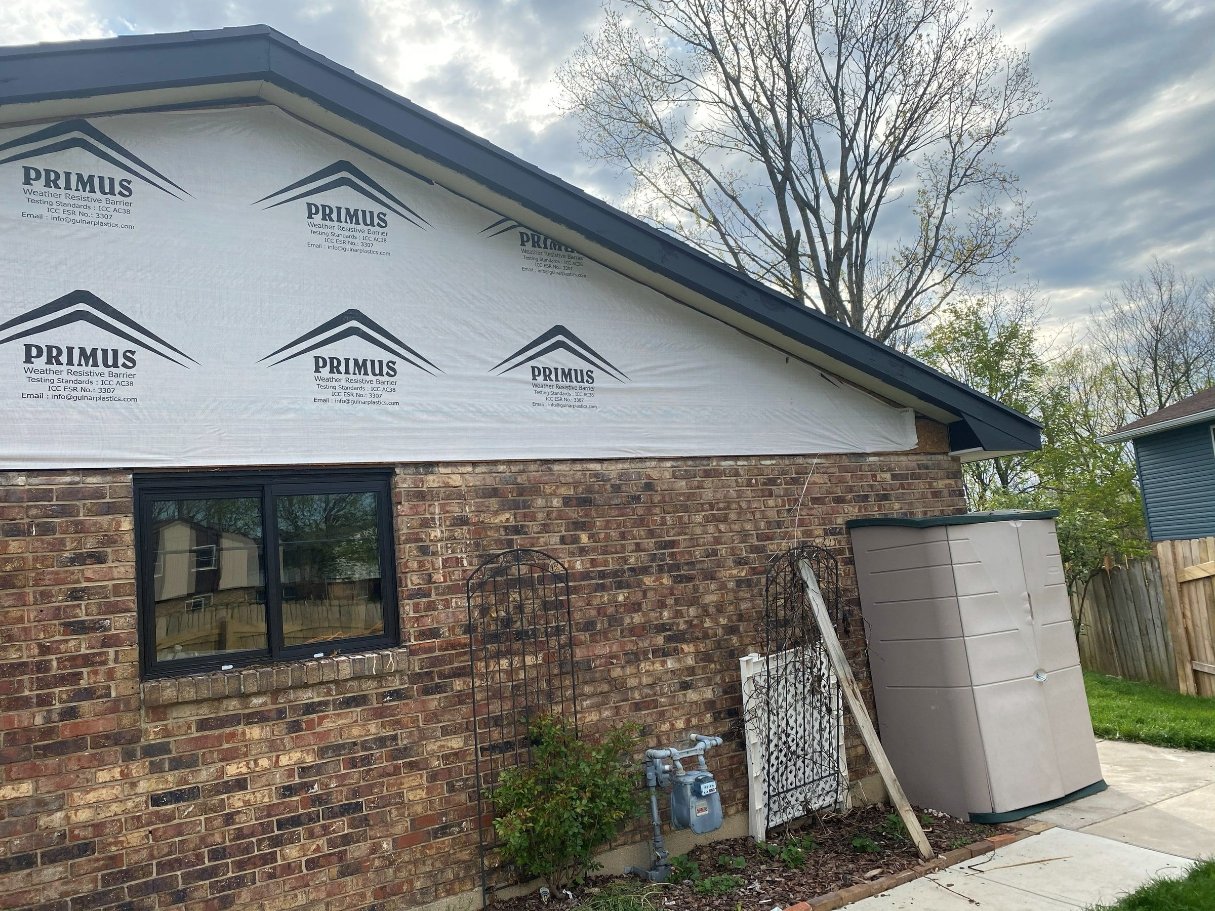 The wrapped gable of the brick wing above the side window, Beavercreek, Ohio.