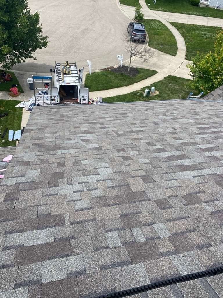Shingles down the slope toward the drive