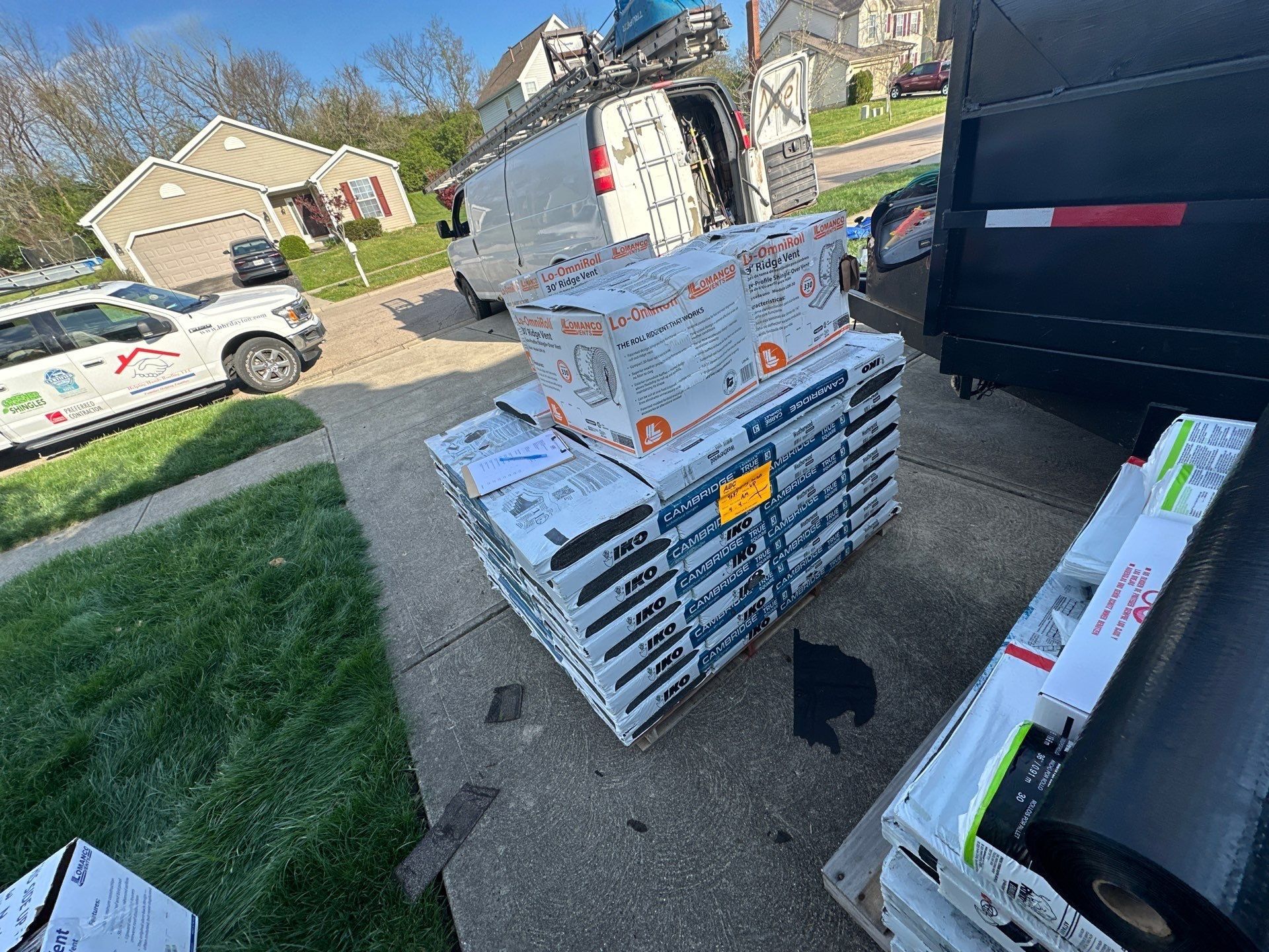 Dumpster and staged materials at the drive