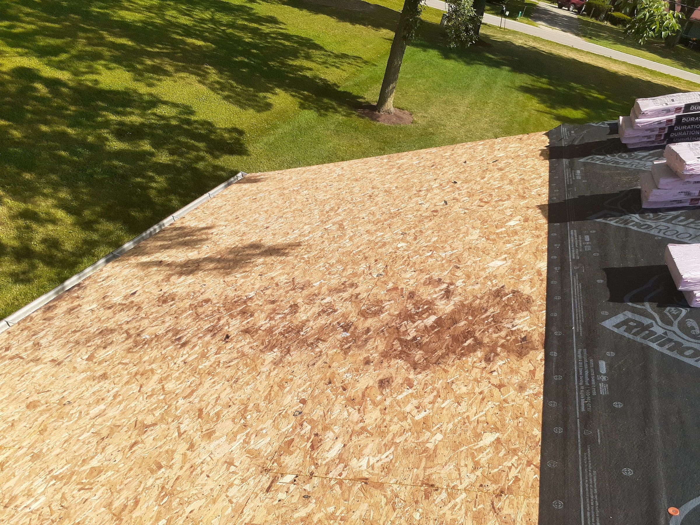Solid original deck beside underlayment already rolled out, Jamestown, Ohio.