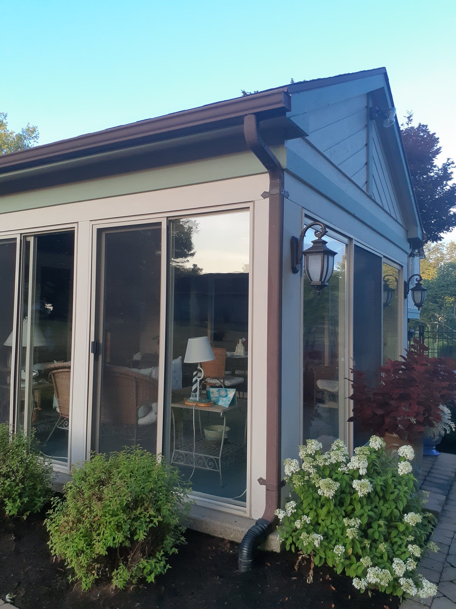 Sunroom glass walls and gable roof from the patio, Jamestown, Ohio.