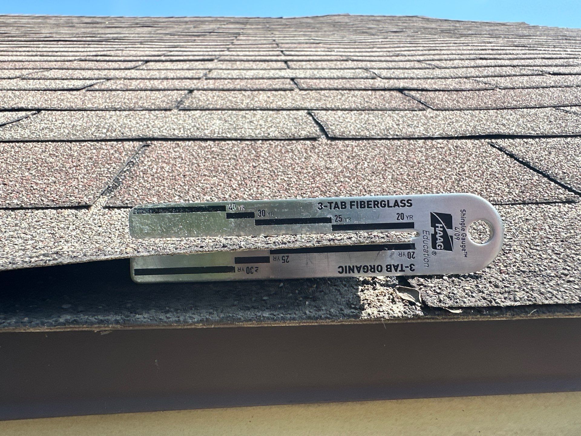A shingle gauge at the roof edge for 20-year and 25-year three-tab, Kettering, Ohio.