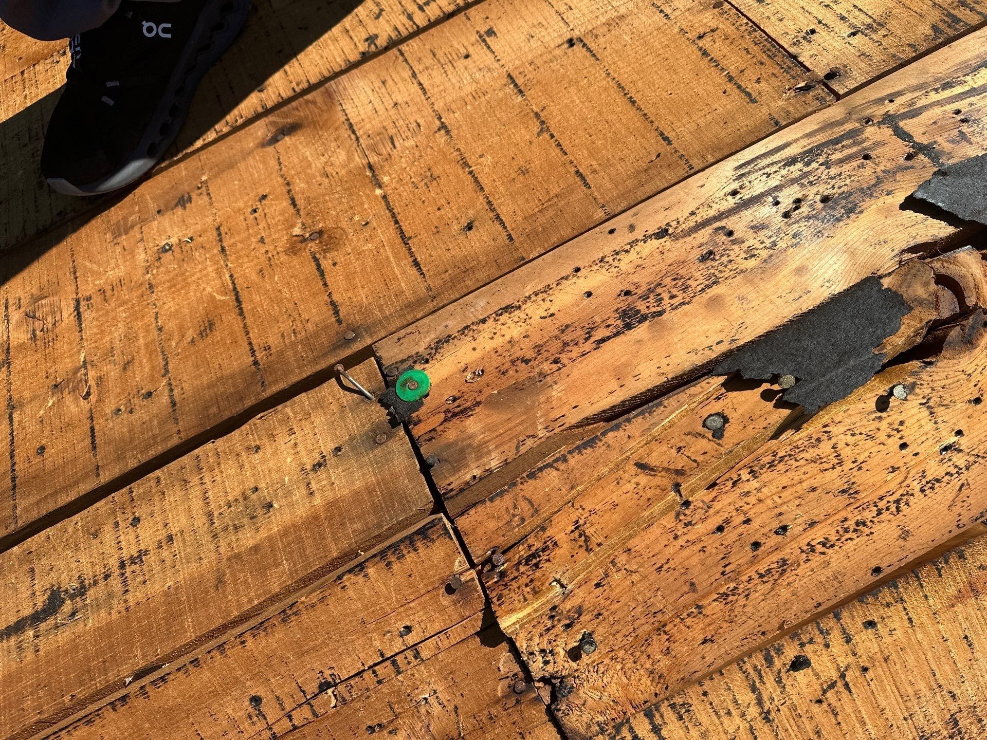 Split and stained deck boards exposed once the old roof was removed, Beavercreek, Ohio.