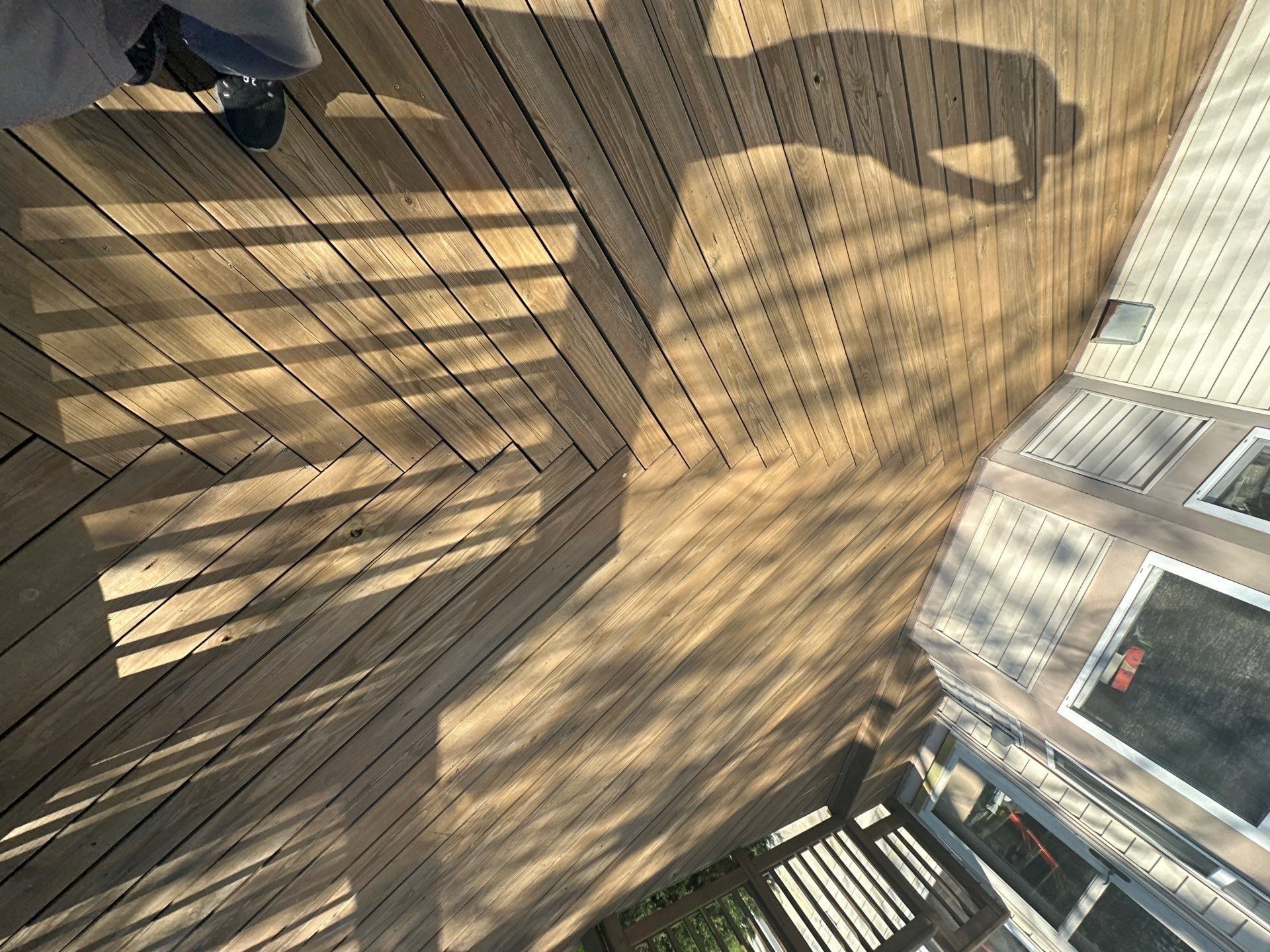 Wooden deck boards and rail shadows