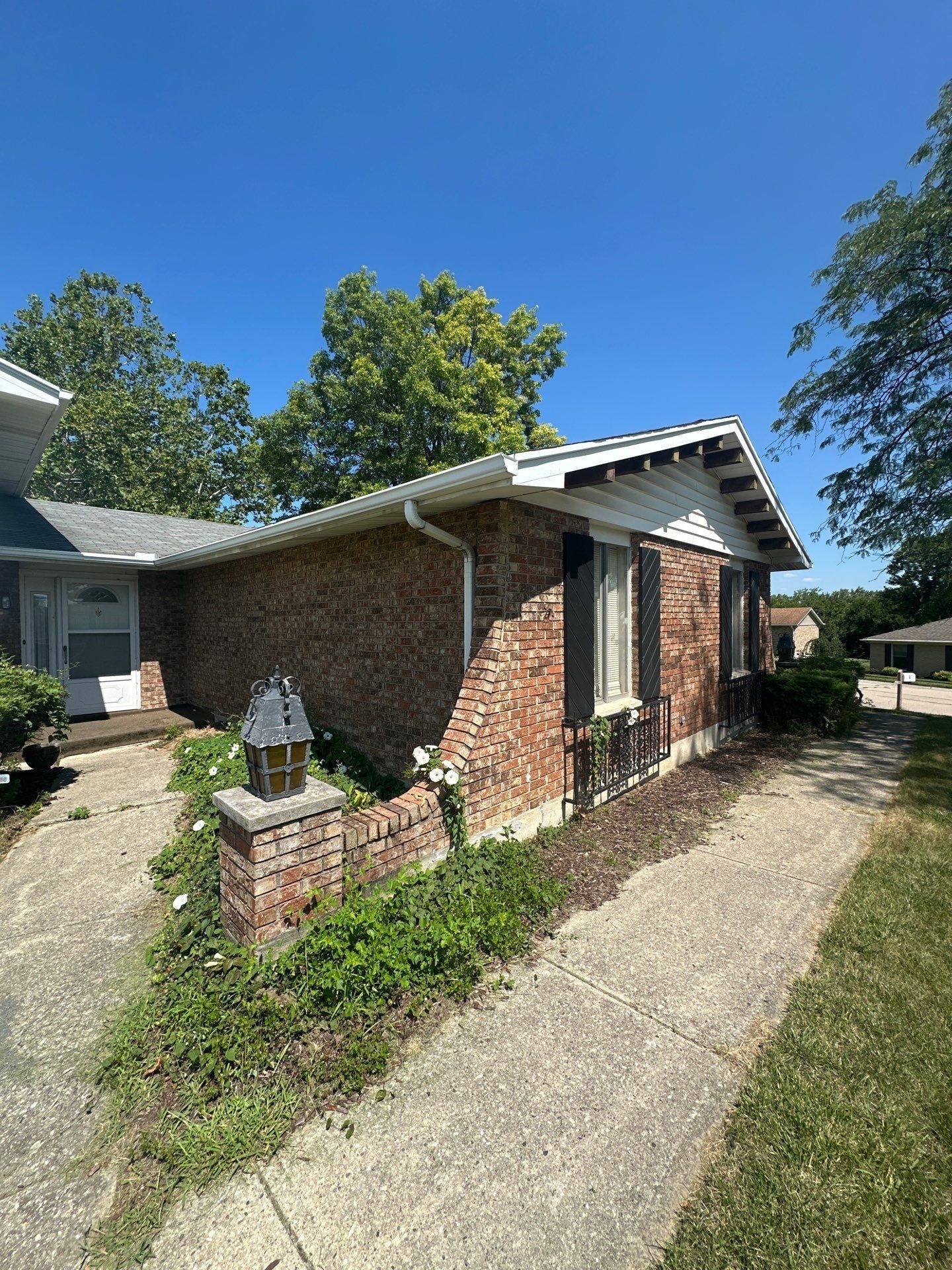The front walk and the corner of the brick wing, with the old roof above, West Carrollton, Ohio.