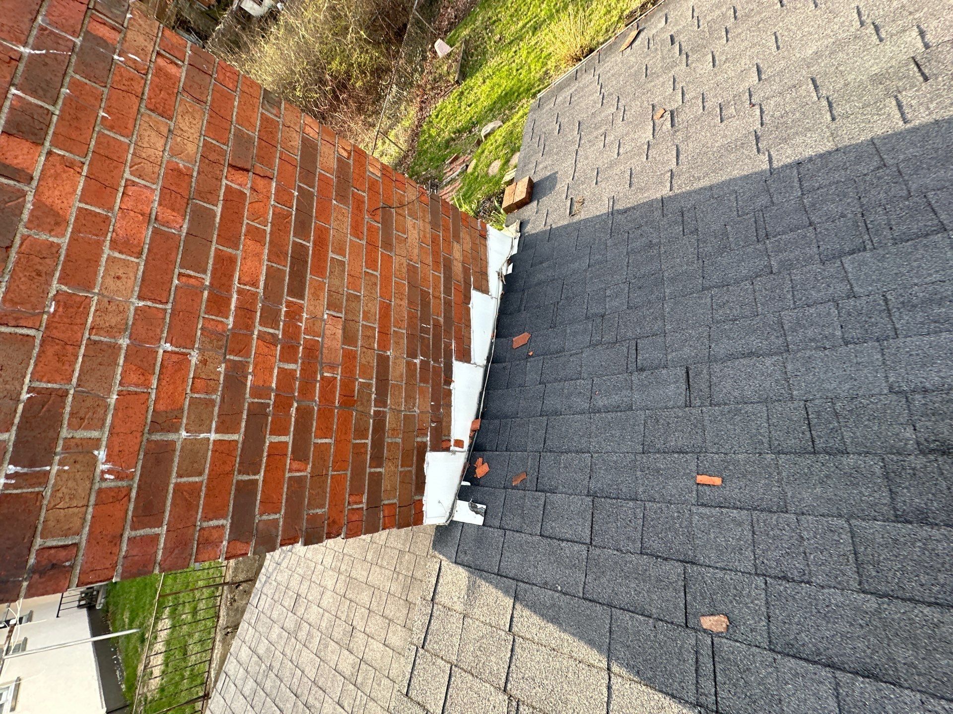 White flashing where shingles meet brick