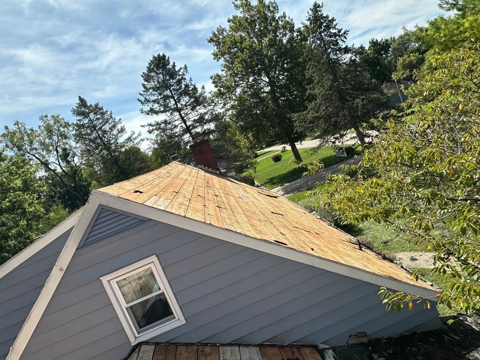 The gable roof bare of shingles beside the dormer window, Beavercreek, Ohio.