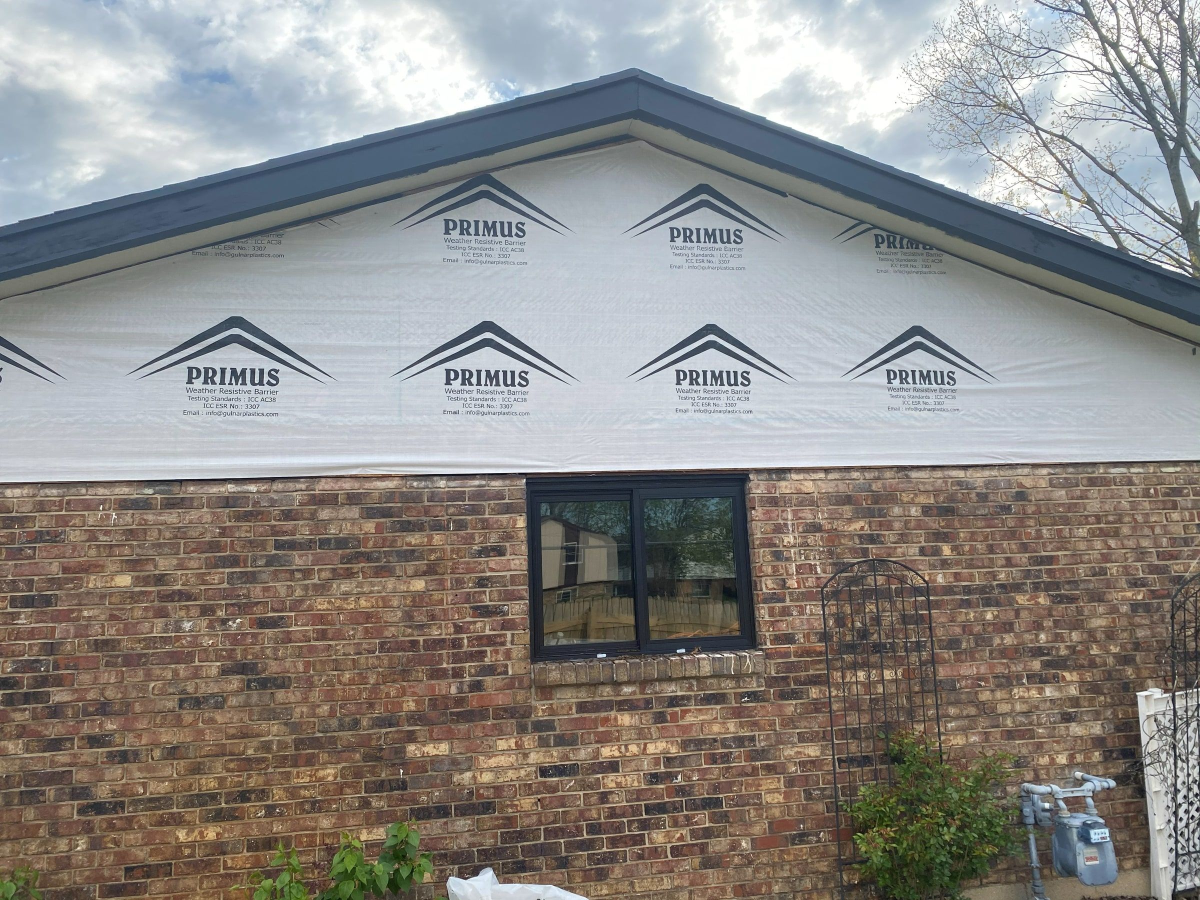 House wrap on the gable of the brick wing, Beavercreek, Ohio.