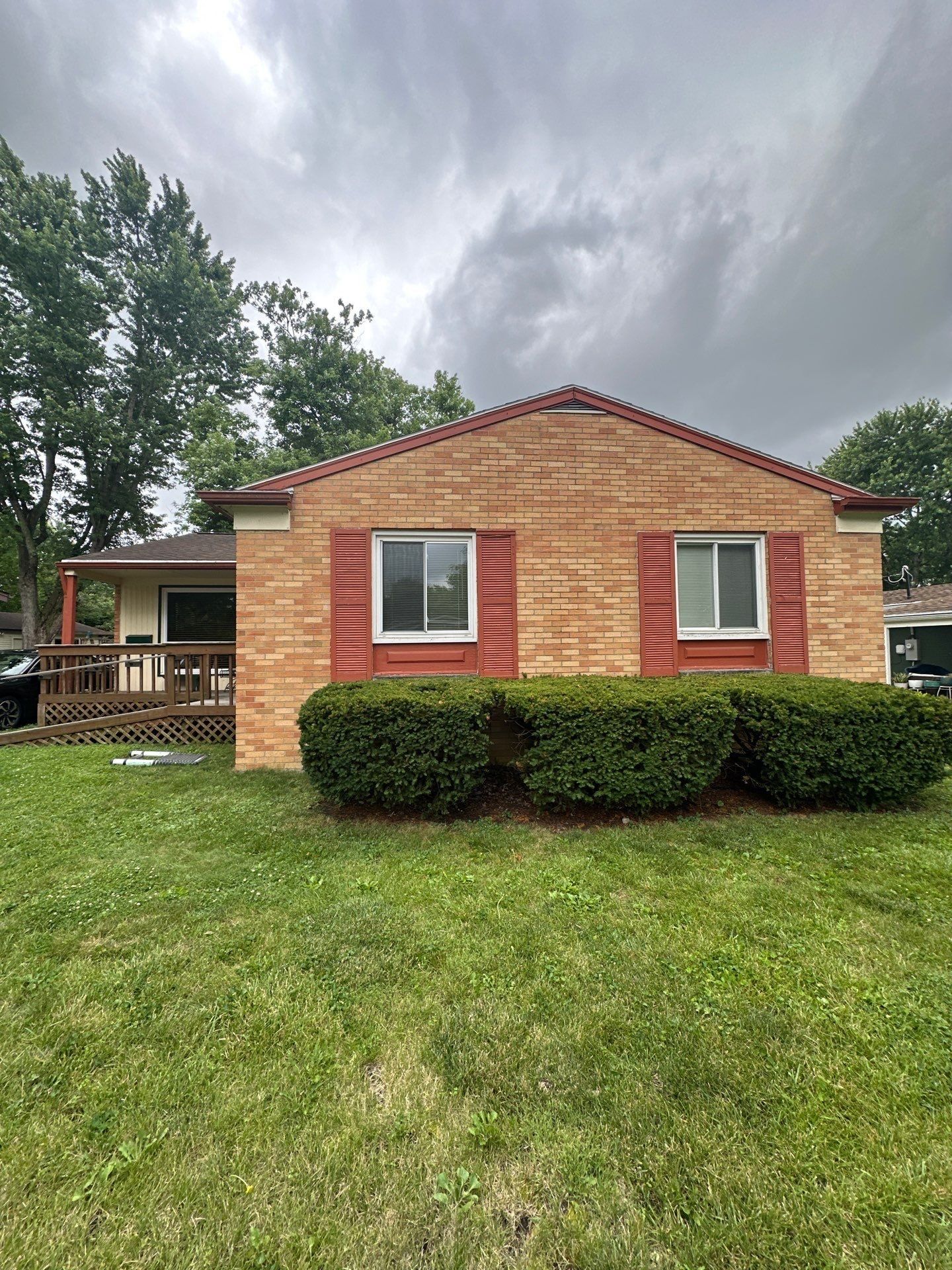 Tan brick gable end and red gutter