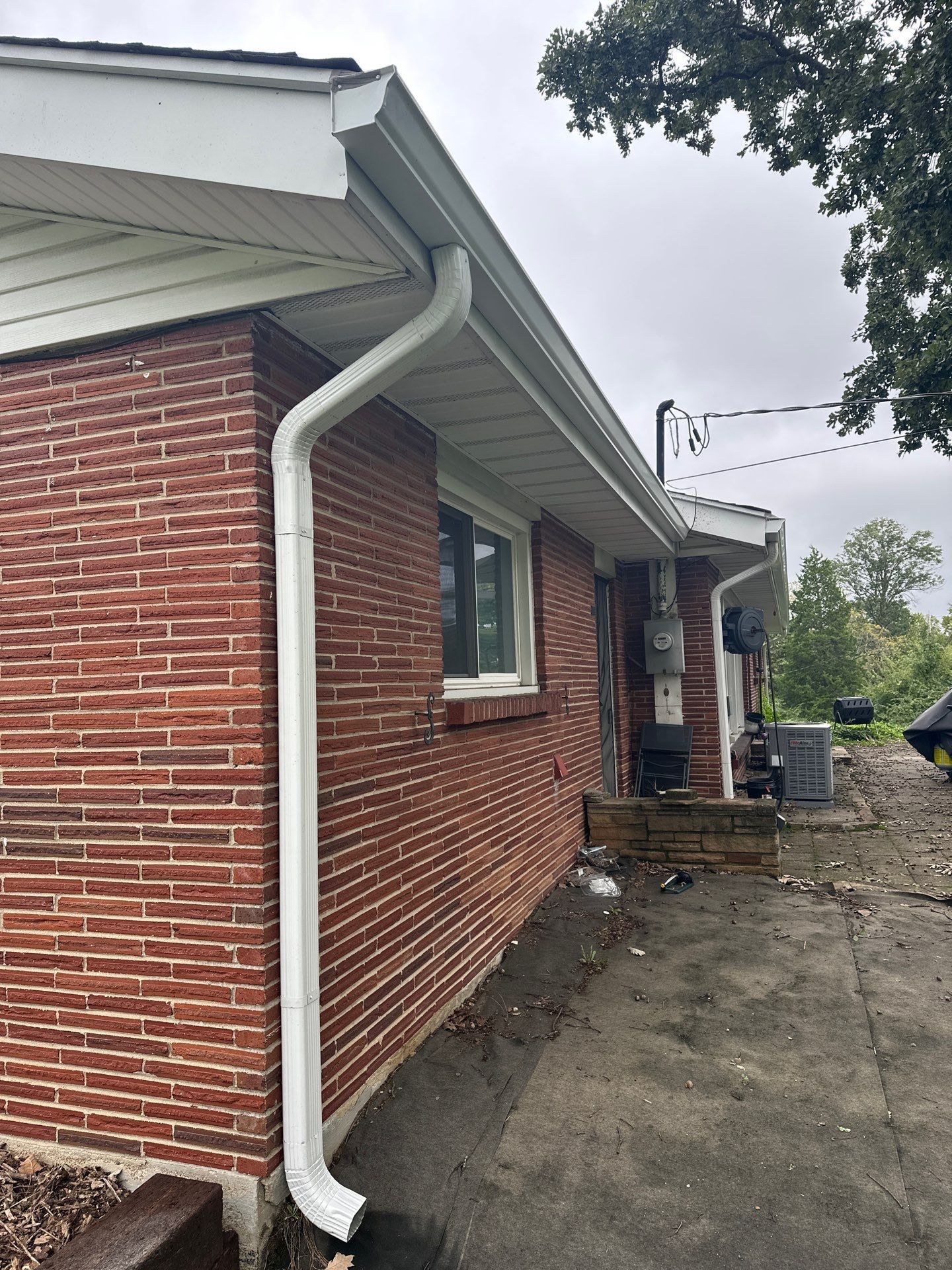 A new gutter and downspout along the long brick side of the house, West Carrollton, Ohio.