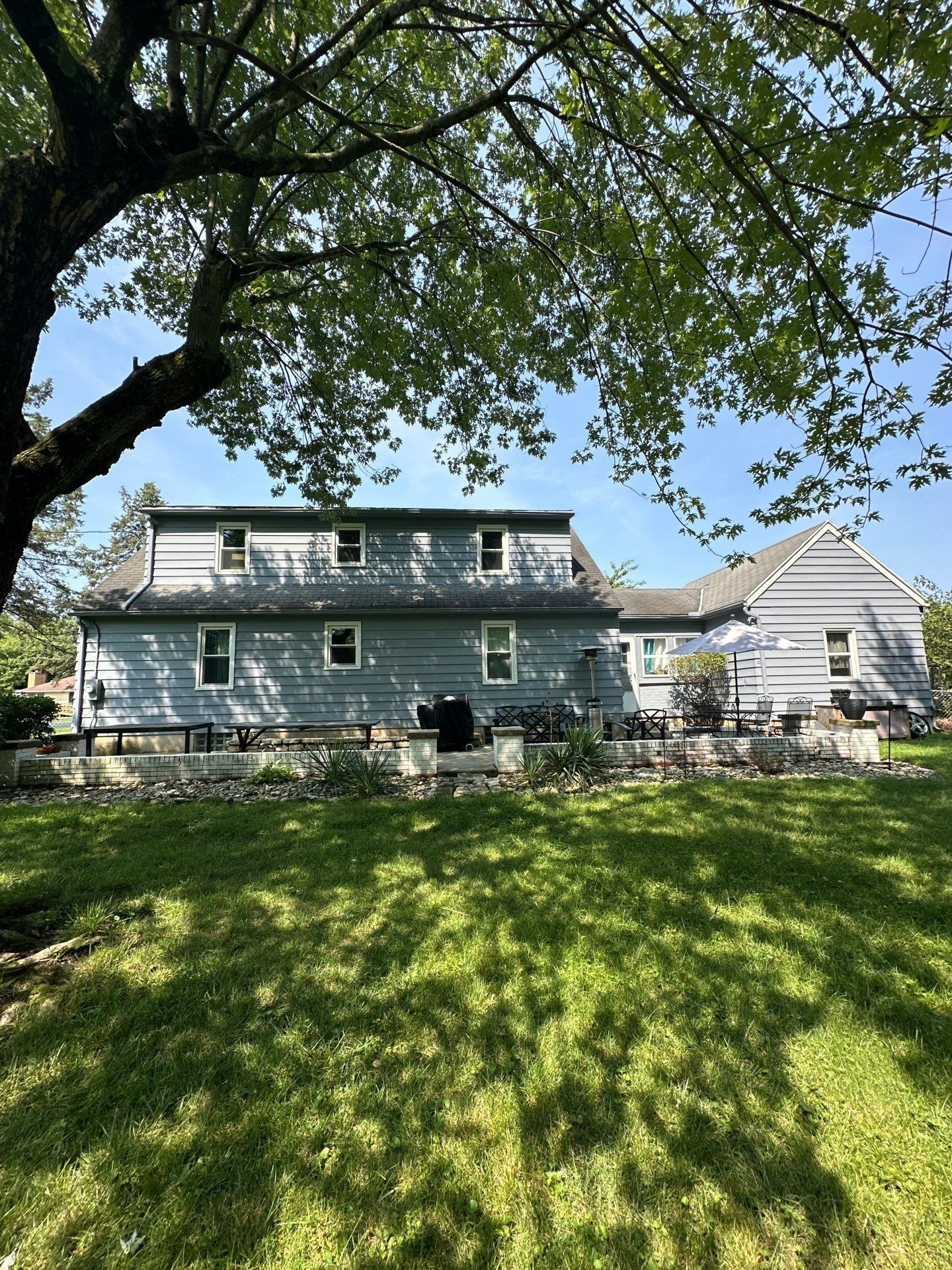 The back of the house across the yard, with the patio, Beavercreek, Ohio.