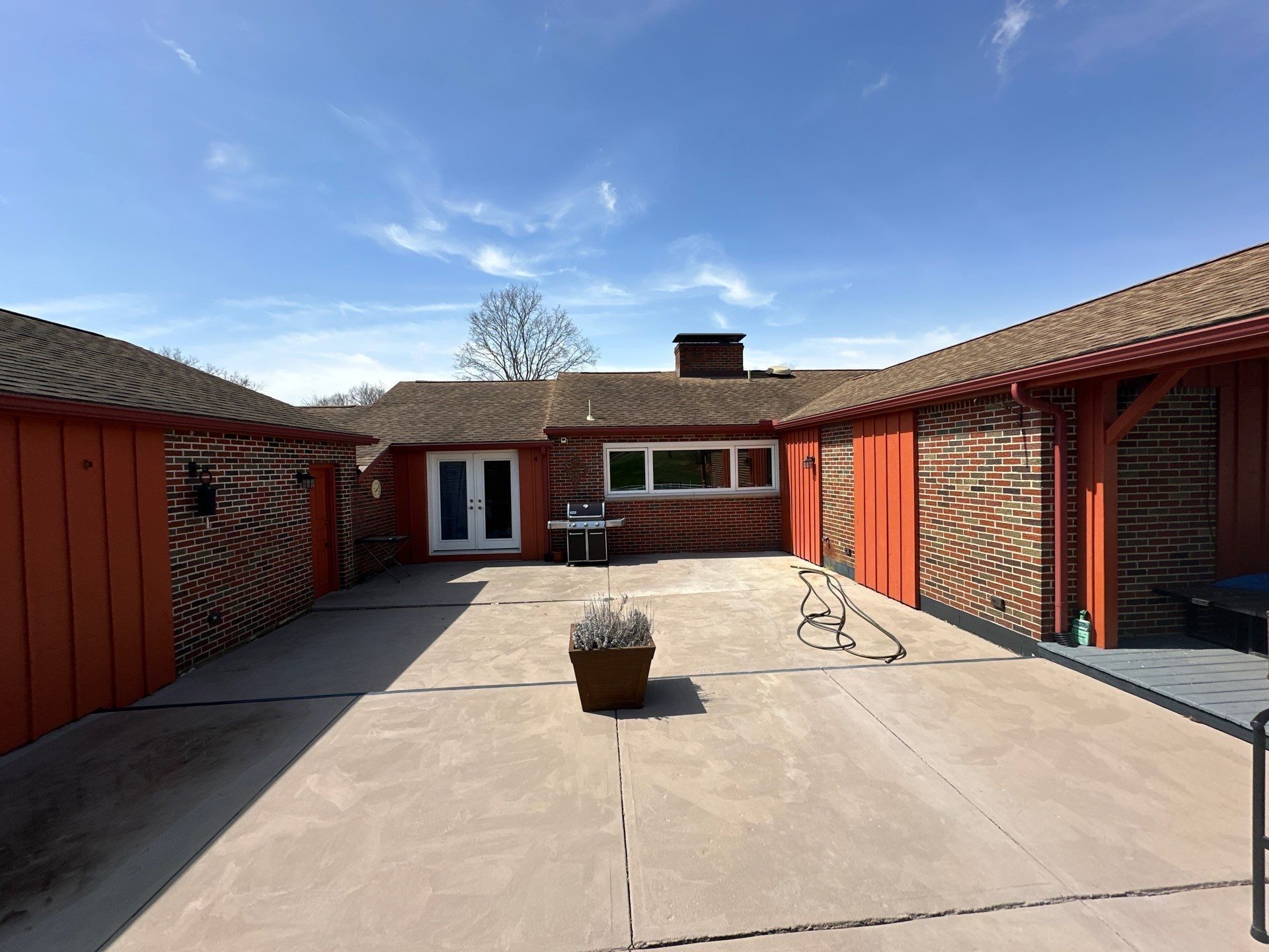 Courtyard and red board-and-batten wings