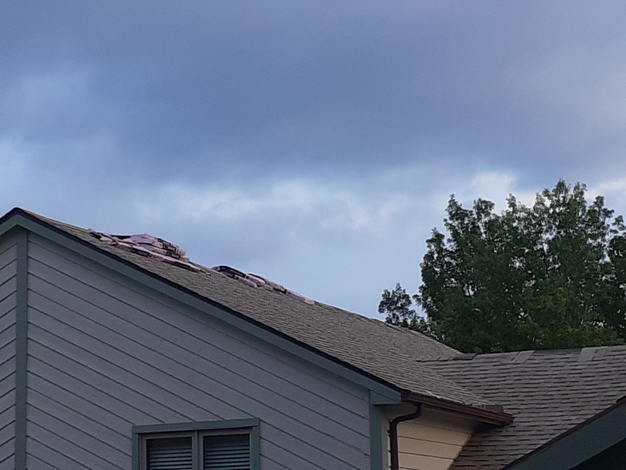 Two story wing gable with shingle bundles staged on top, Jamestown, Ohio.