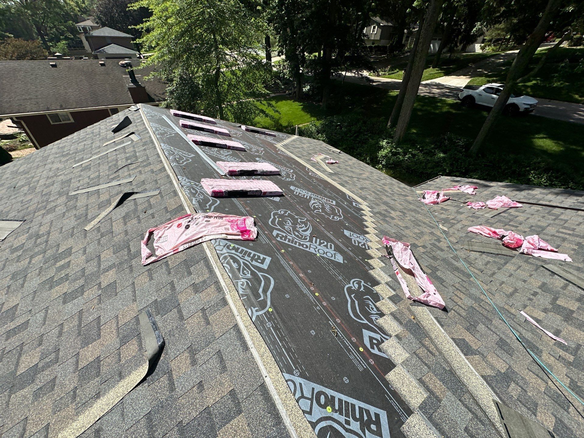 Shingles going on up to the hips with bundles waiting on the ridge, Beavercreek, Ohio.