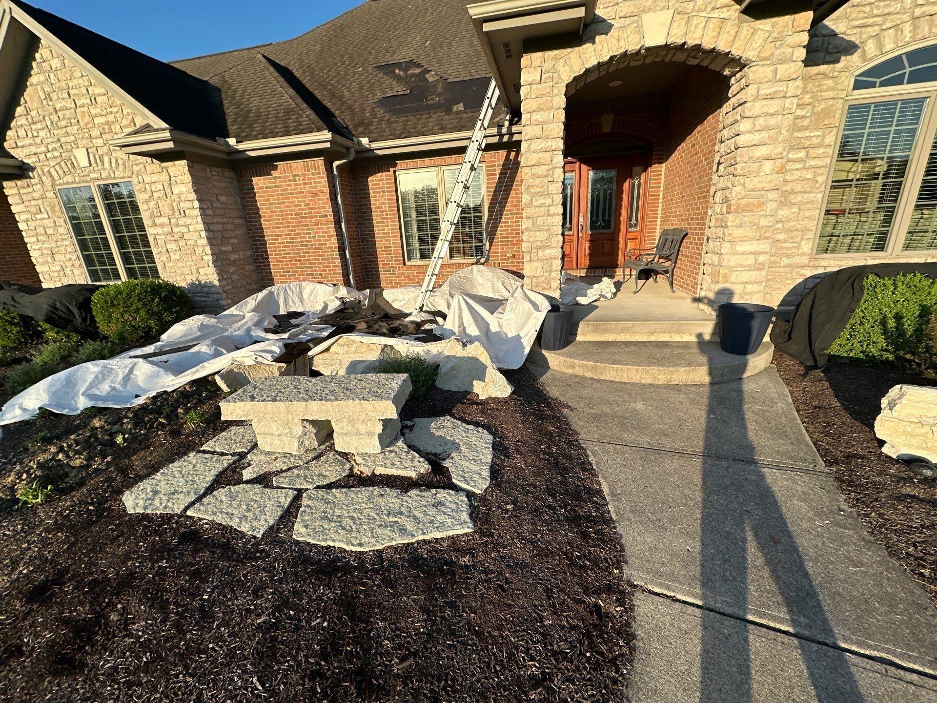 Tarps at the front entry and ladder