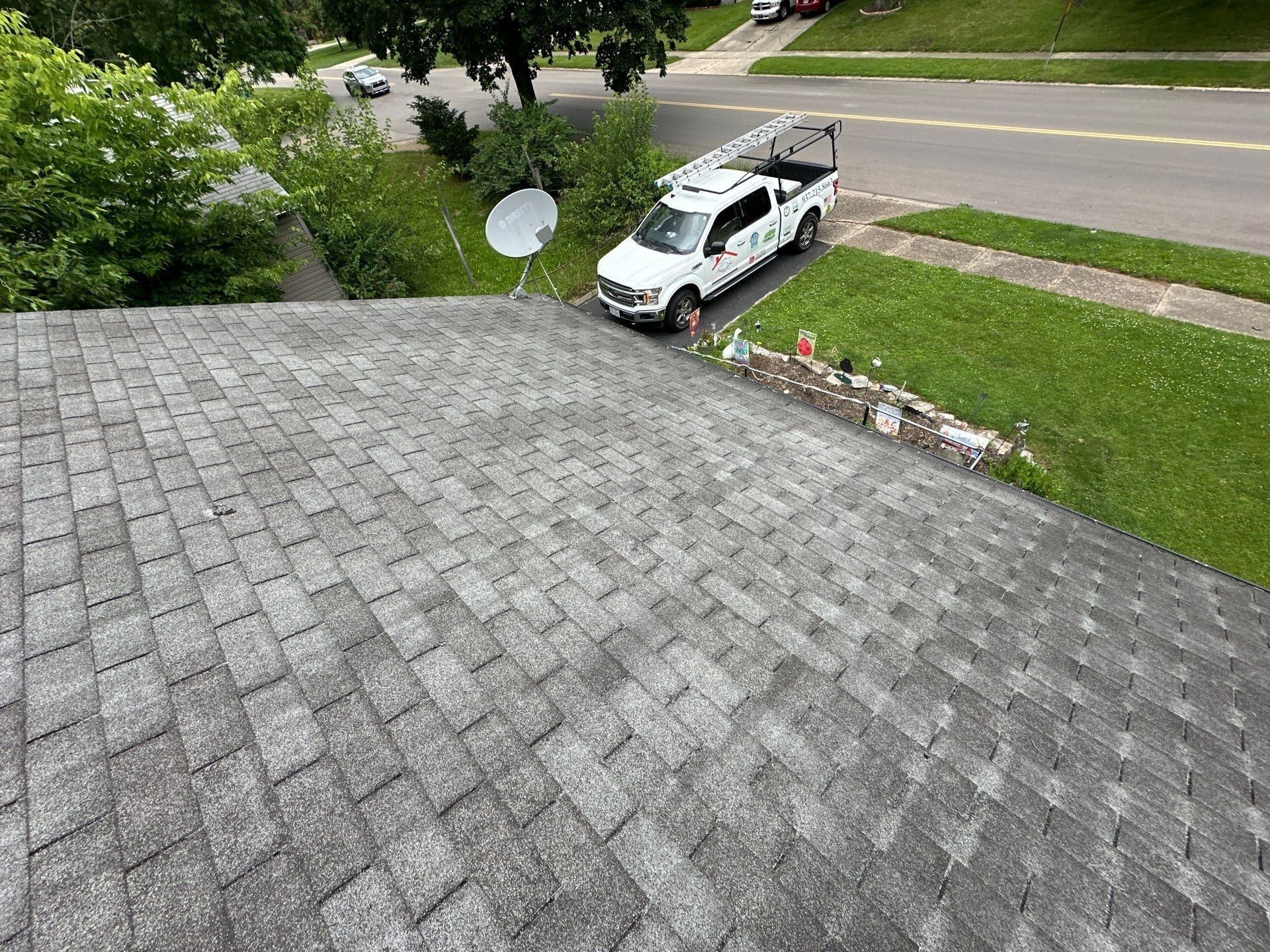 Old roof, company pickup and satellite dish