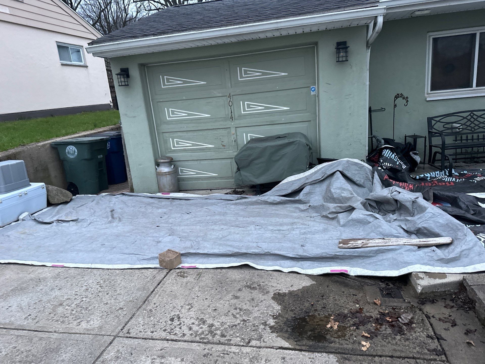 A tarp laid over the driveway in front of the garage, Dayton, Ohio.
