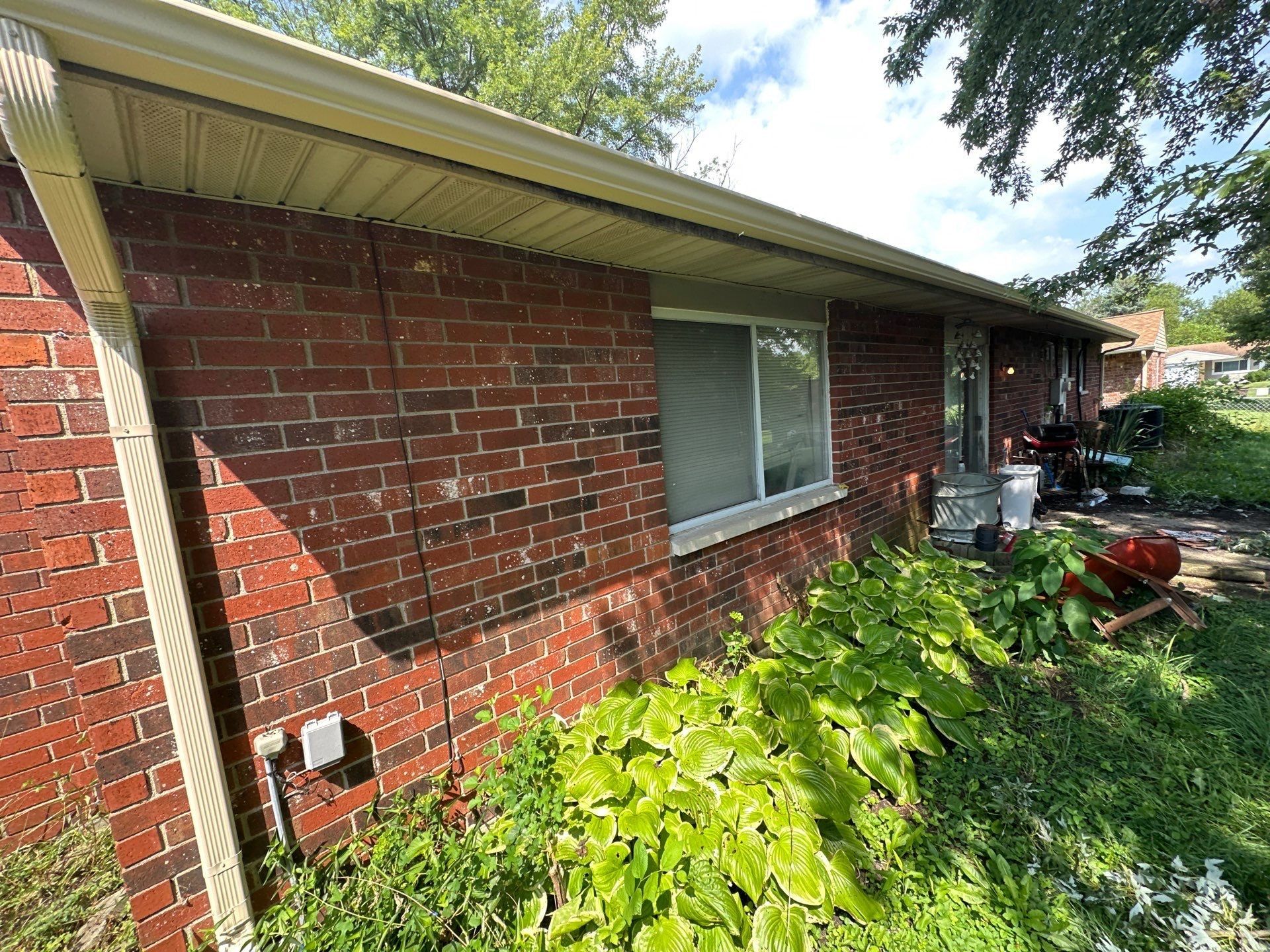 Sandtone gutter and downspout on brick