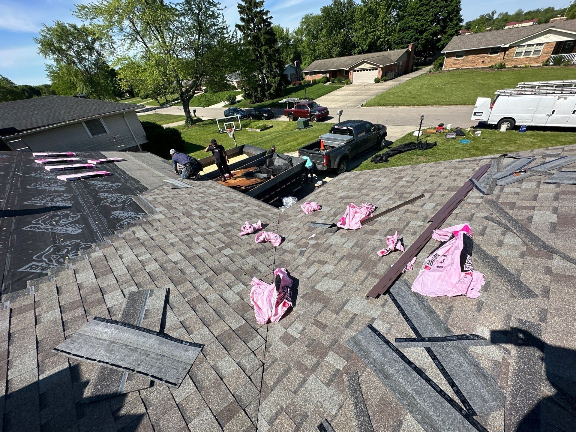 New shingles on the front slopes, with wrapper scraps on top, Beavercreek, Ohio.