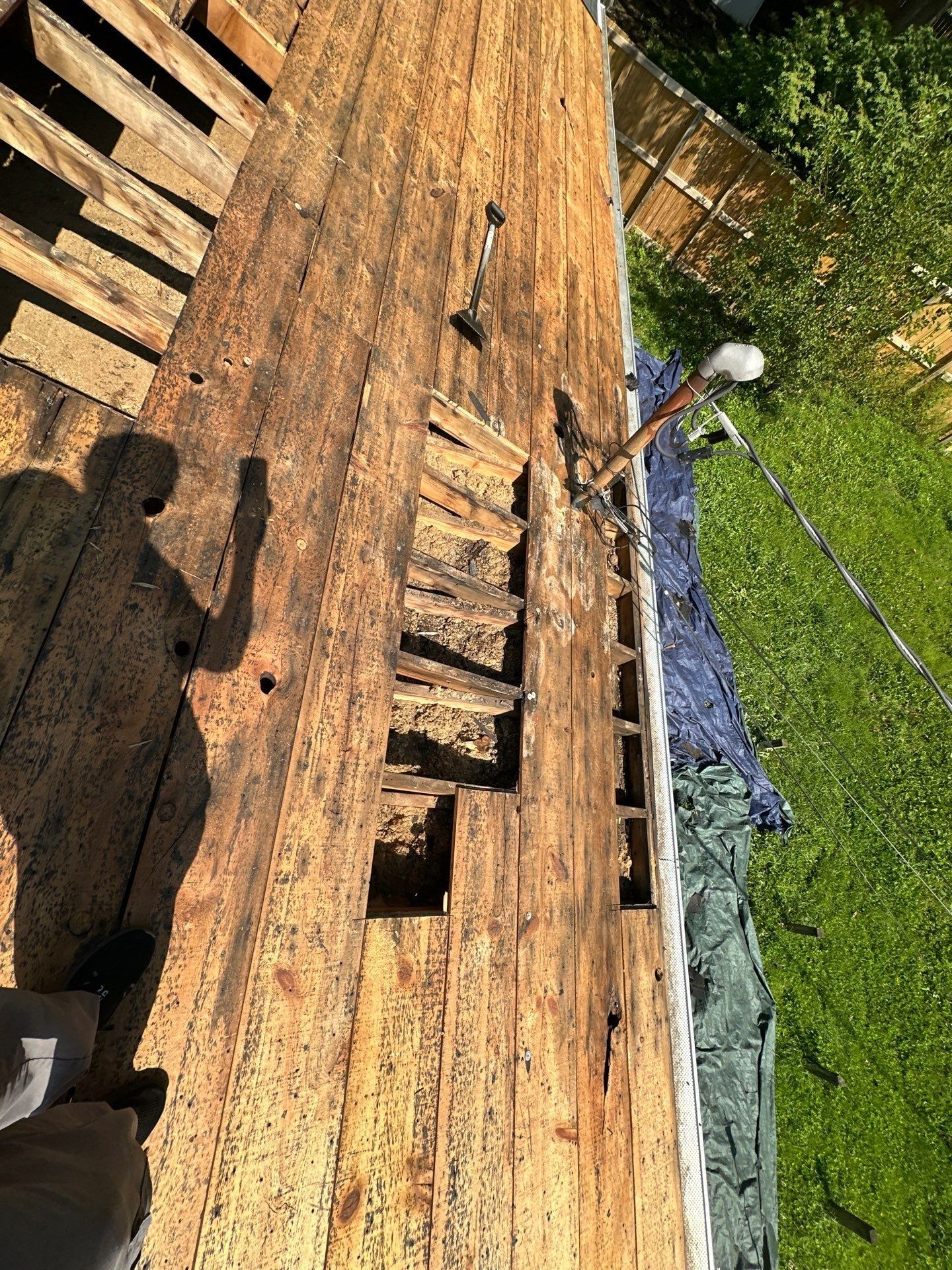 Rotted deck boards cut out near the roof edge above the back yard, Fairborn, Ohio.