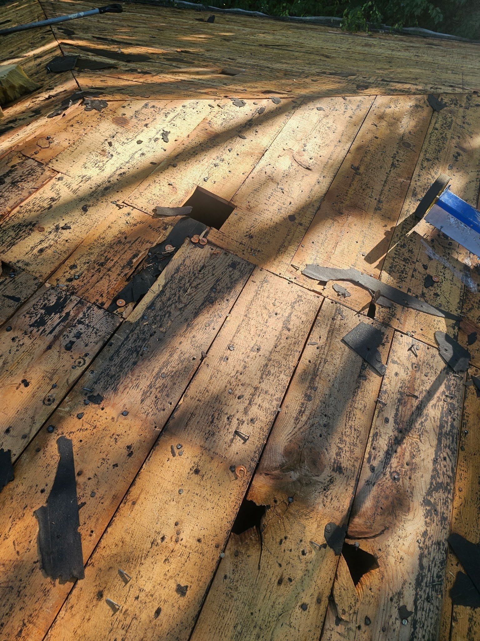 A rotted spot in the plank deck beside a vent opening, Kettering, Ohio.