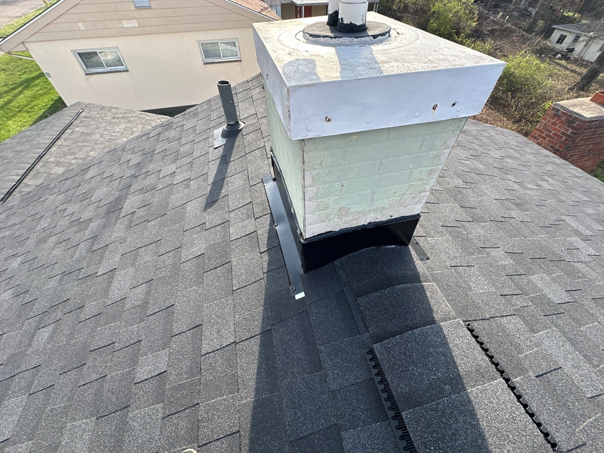 New black flashing around the faux chimney on the finished roof, Dayton, Ohio.