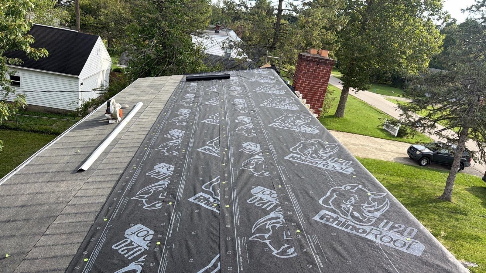 Synthetic underlayment across the roof, with the chimney beyond, Beavercreek, Ohio.