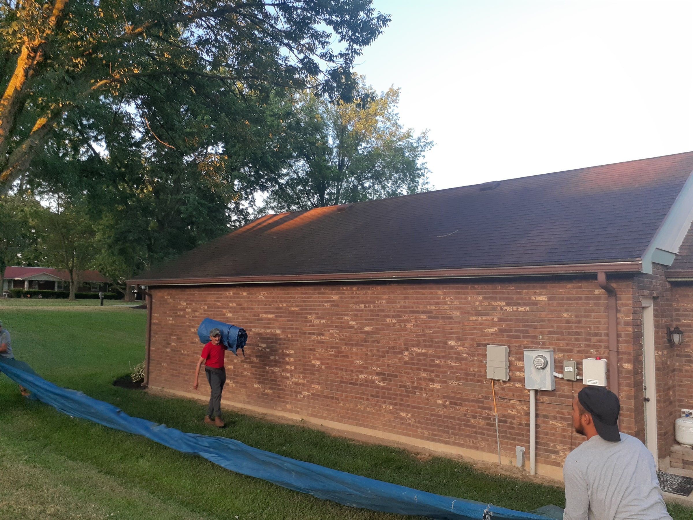 Crew laying tarps along the wall to catch debris before tear-off, Jamestown, Ohio.