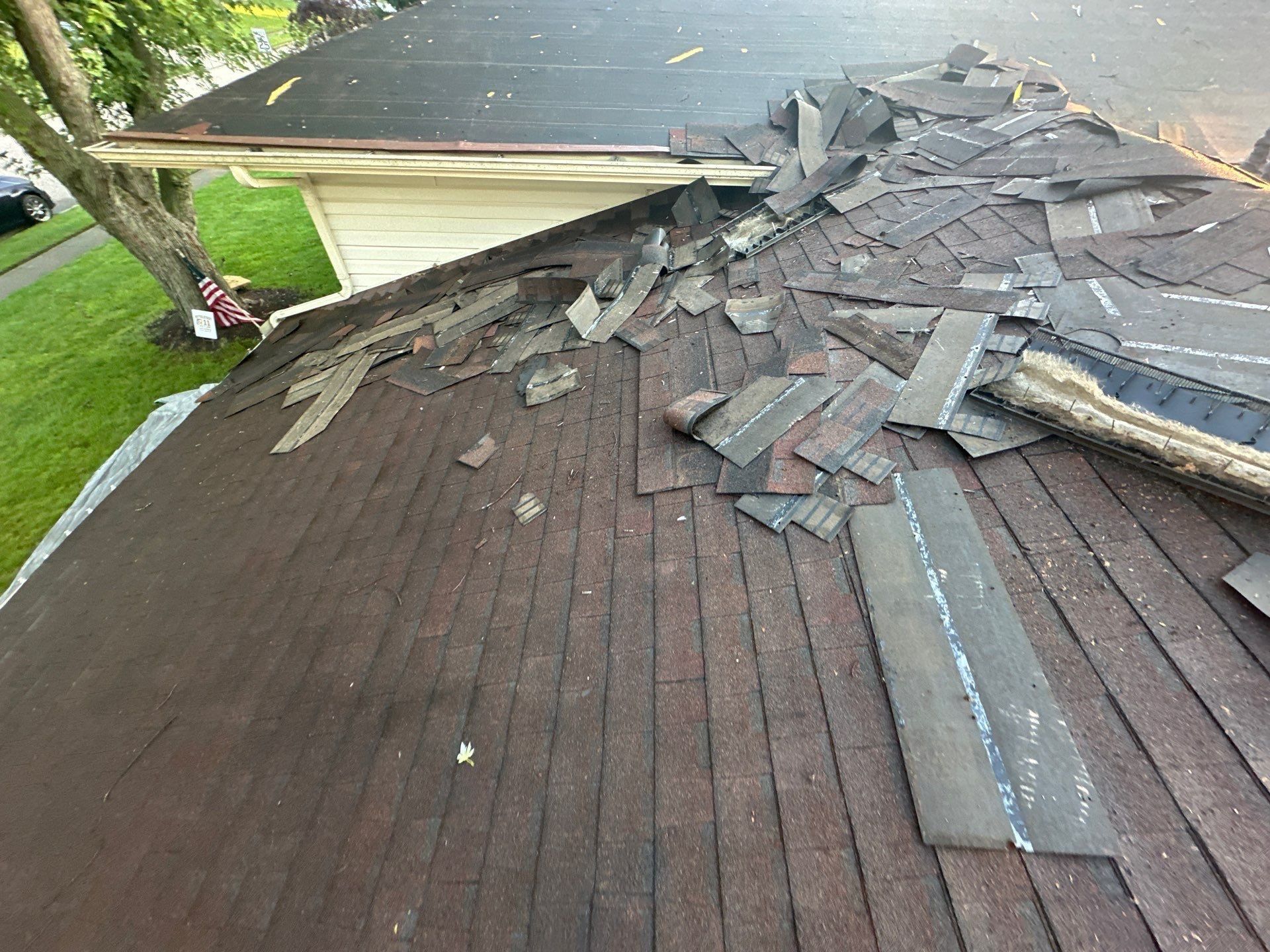 Old shingles piling up on the roof as the tear-off starts, Dayton, Ohio.