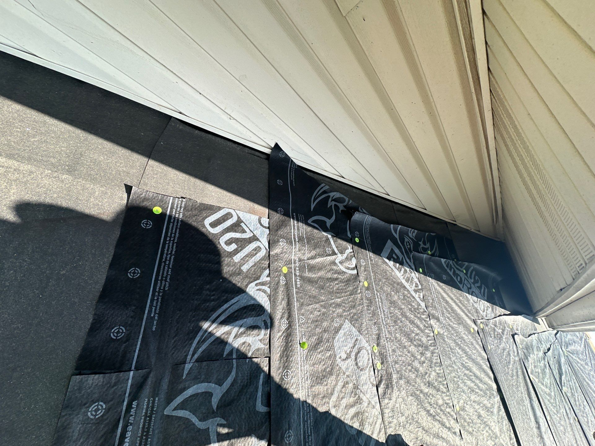 Ice and water shield turned up the wall at the corner where the roof meets the siding, Dayton, Ohio.