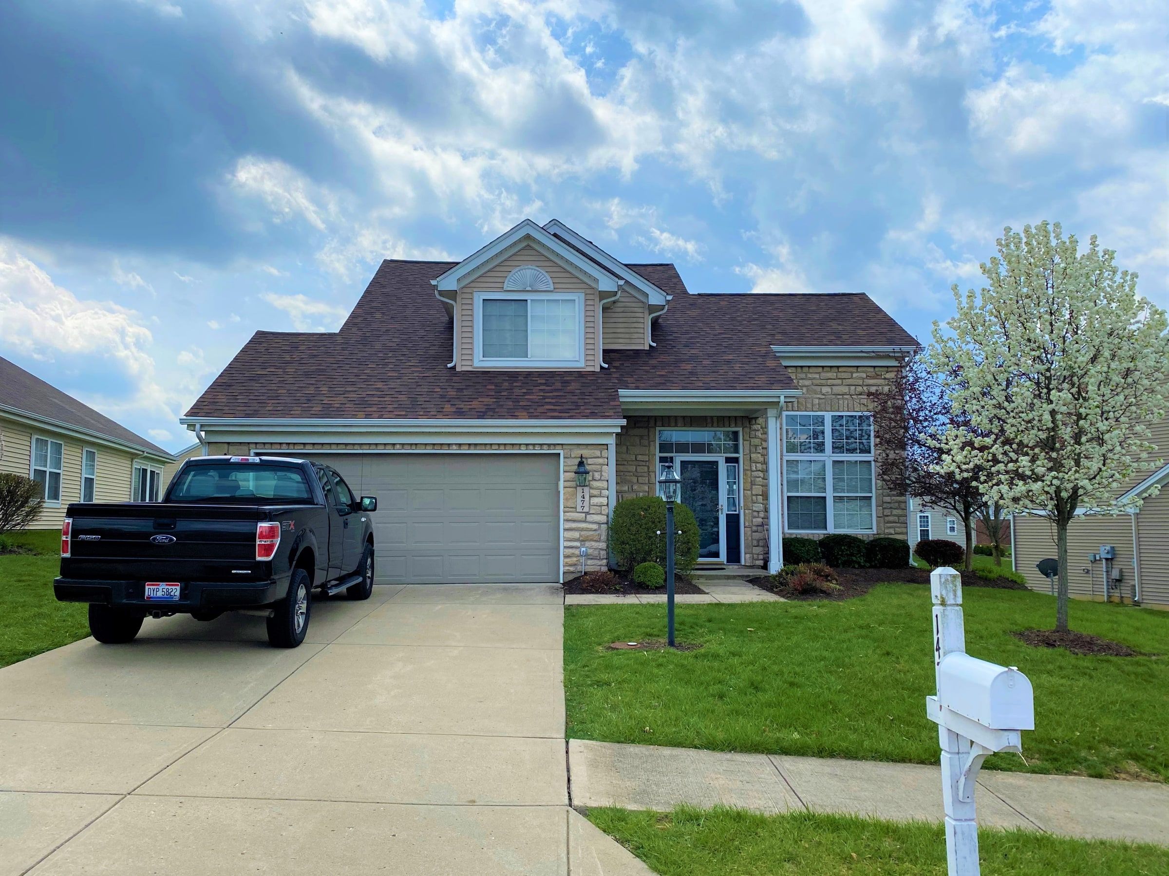The two-story home with its new brown roof, seen from the street, Xenia, Ohio.