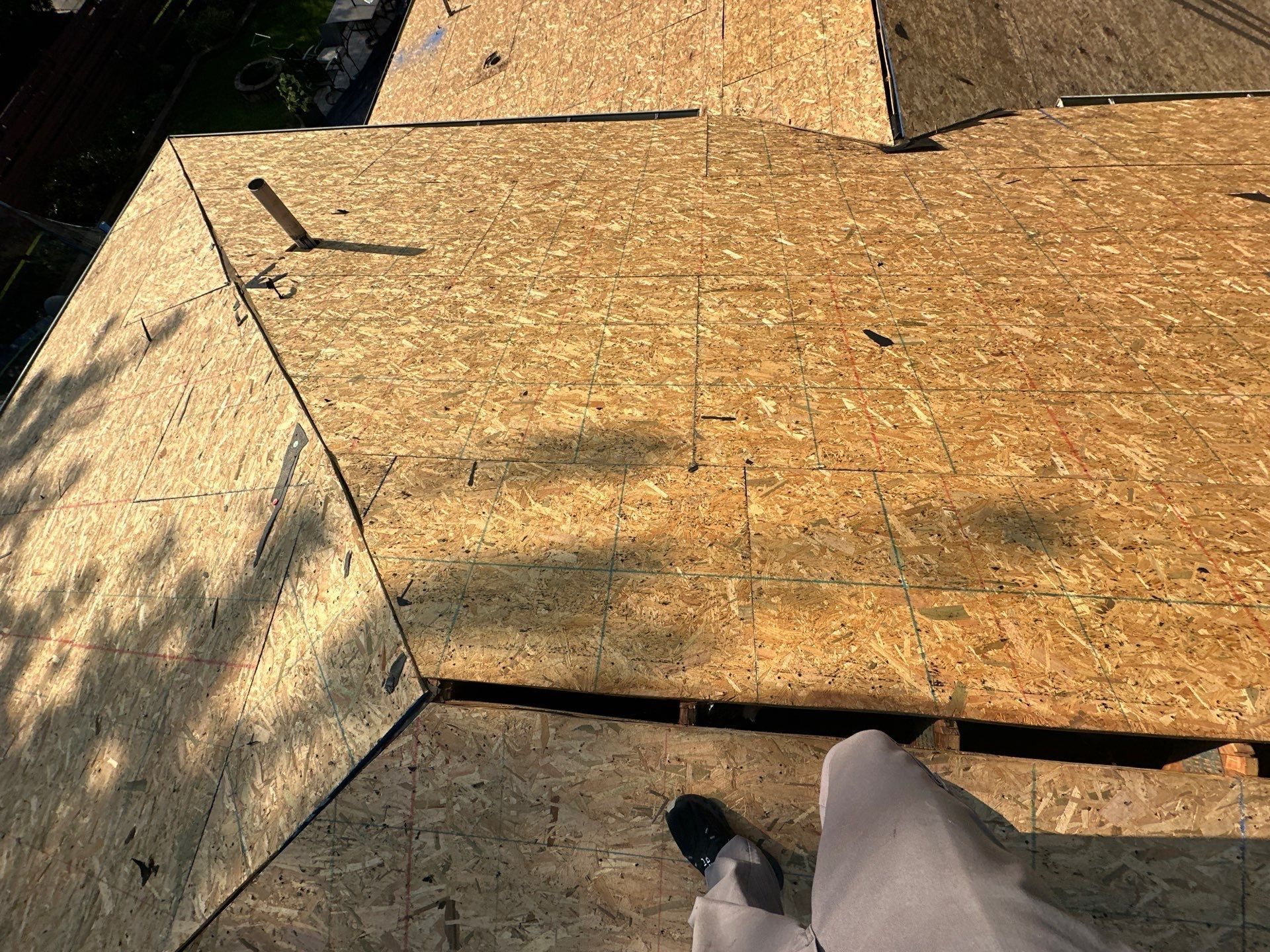 The clean deck where two roof sections meet, with the ridge open for the vent, Dayton, Ohio.