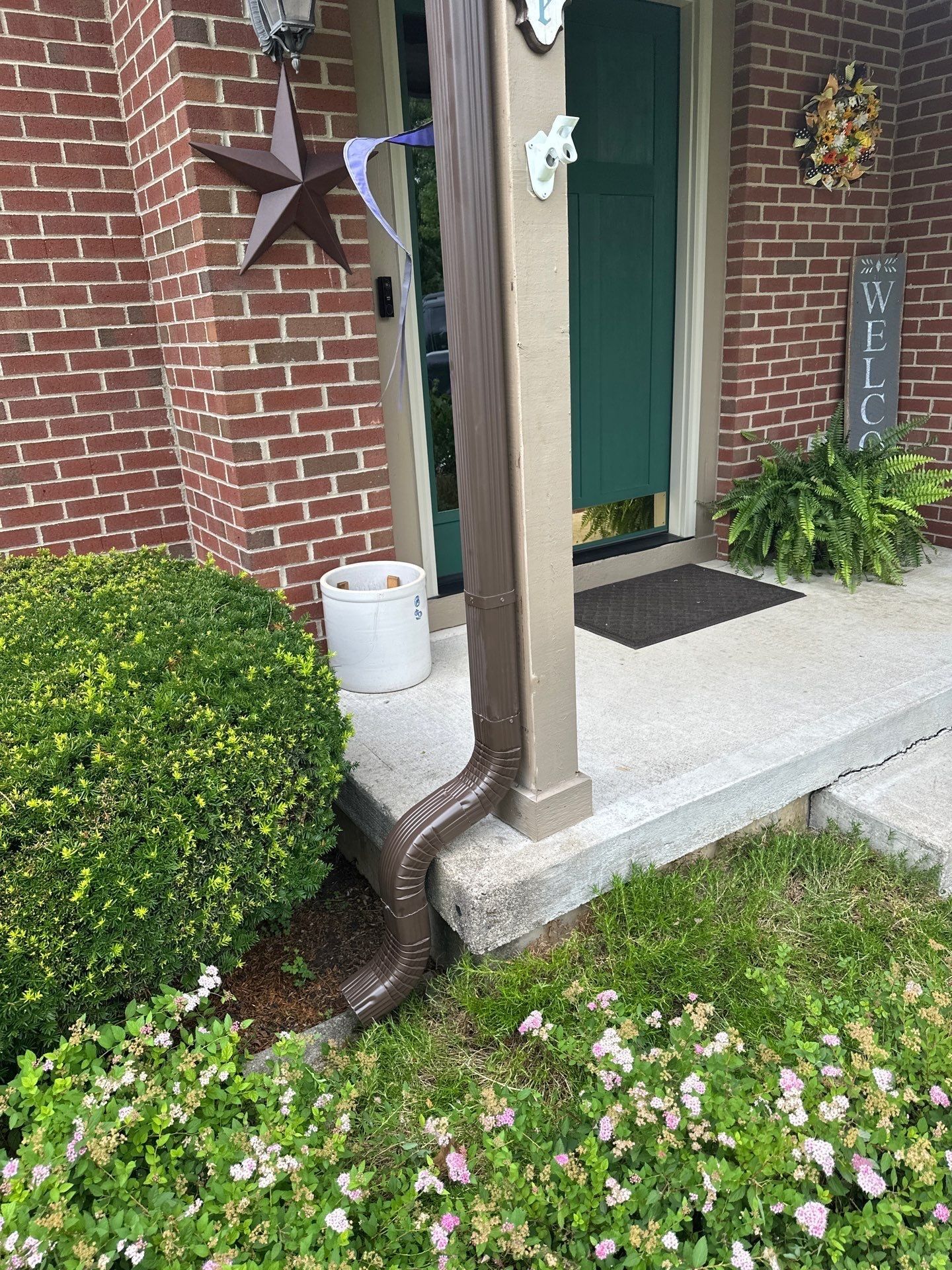 Downspout down the brick to the border