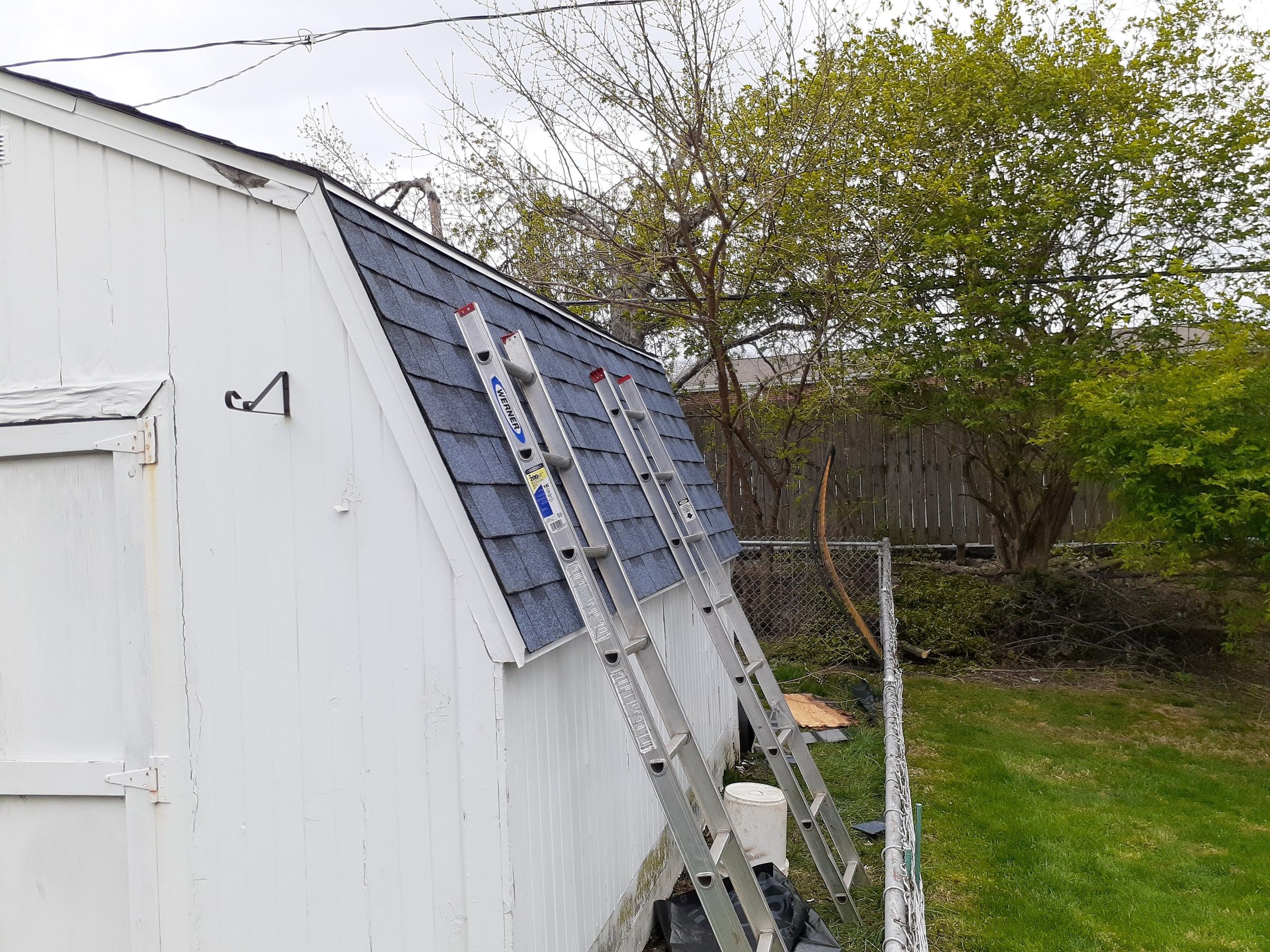 The new shingles on the shed's gambrel roof, with ladders against it, Kettering, Ohio.