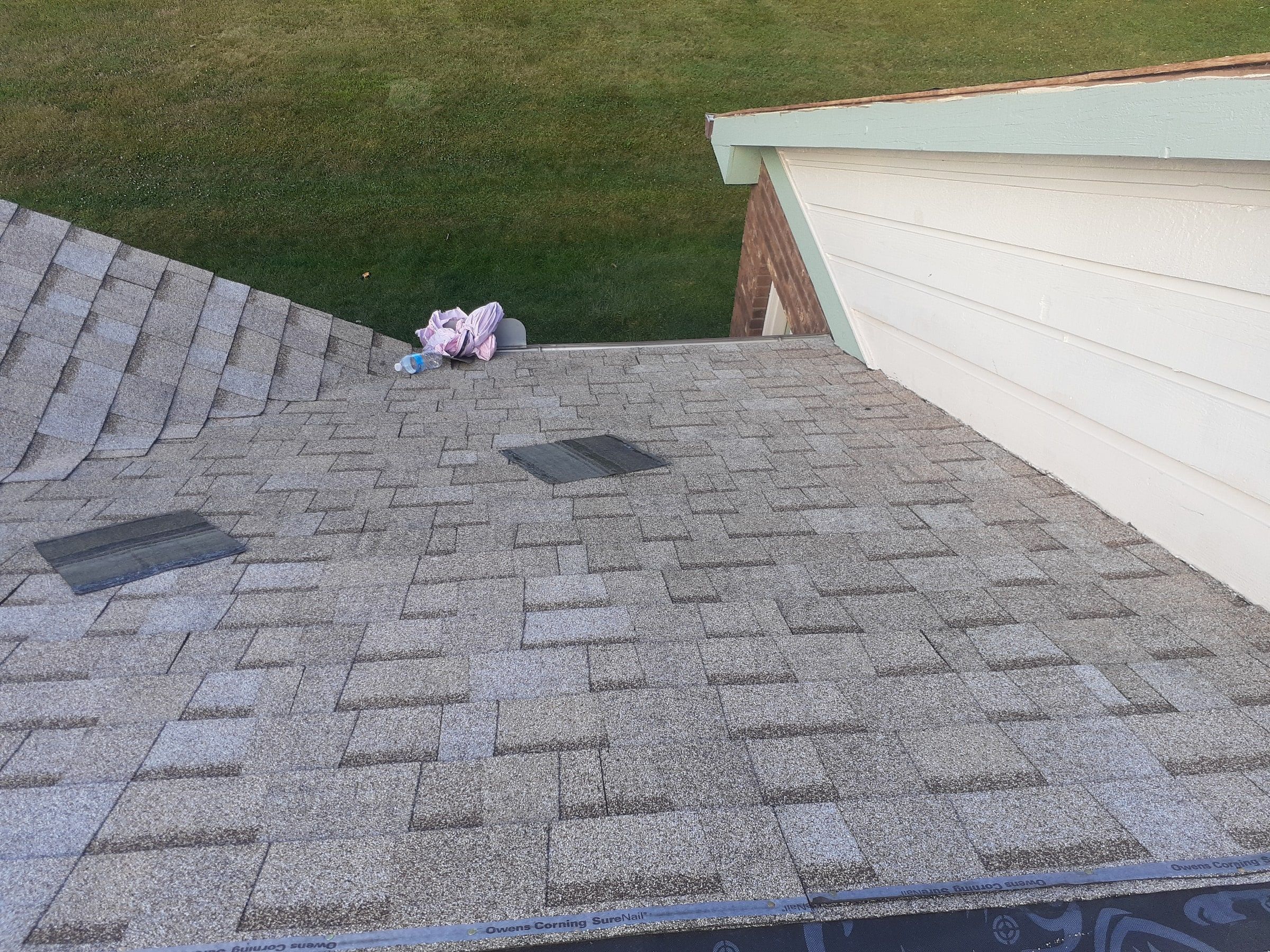 New shingles reaching up to the siding of the two story wing, Jamestown, Ohio.