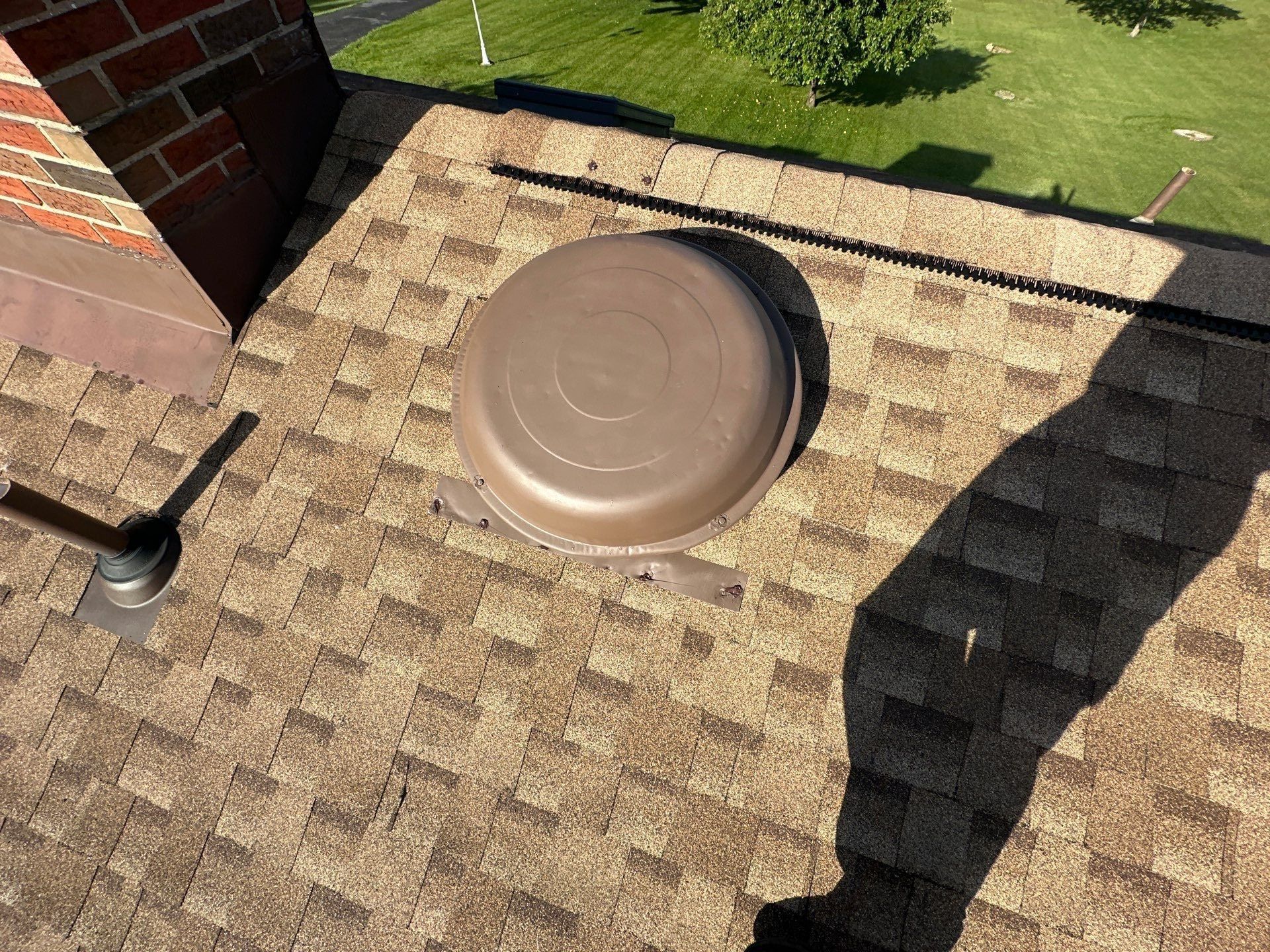 A roof vent and the brick chimney on the repaired back slope, Clayton, Ohio.
