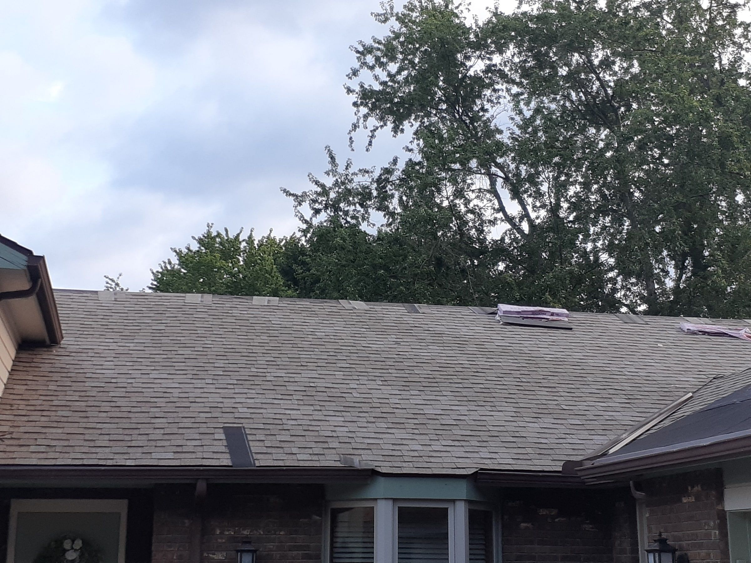 Front roof shingled with bundles still waiting on the ridge, Jamestown, Ohio.