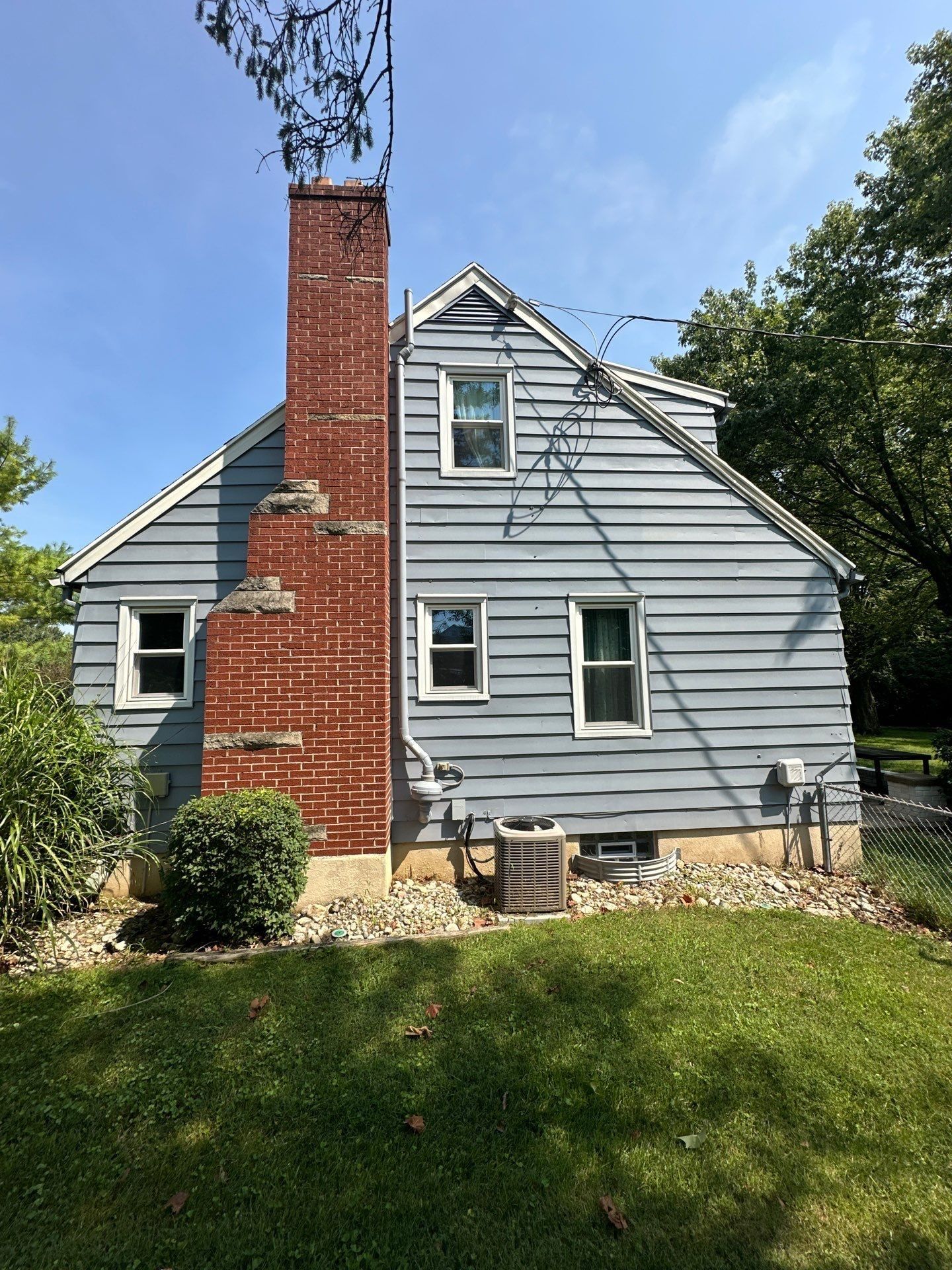 The chimney side of the house, with the air conditioner below, Beavercreek, Ohio.