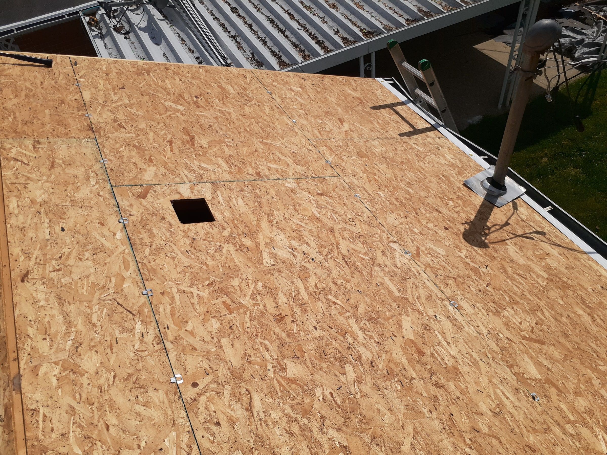 New OSB on the garage roof with an opening for a roof vent, Huber Heights, Ohio.