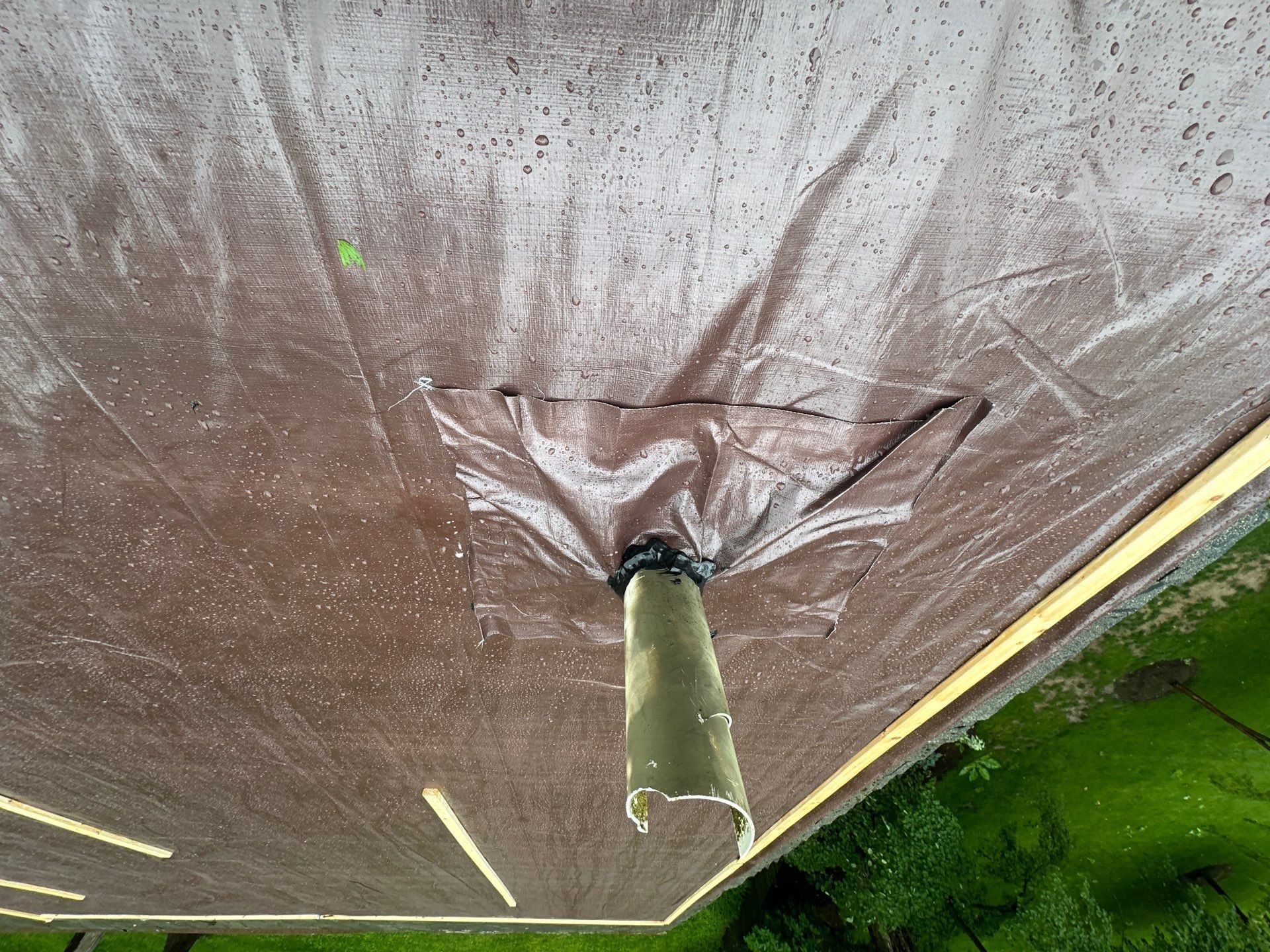 Brown tarp sealed at the vent collar