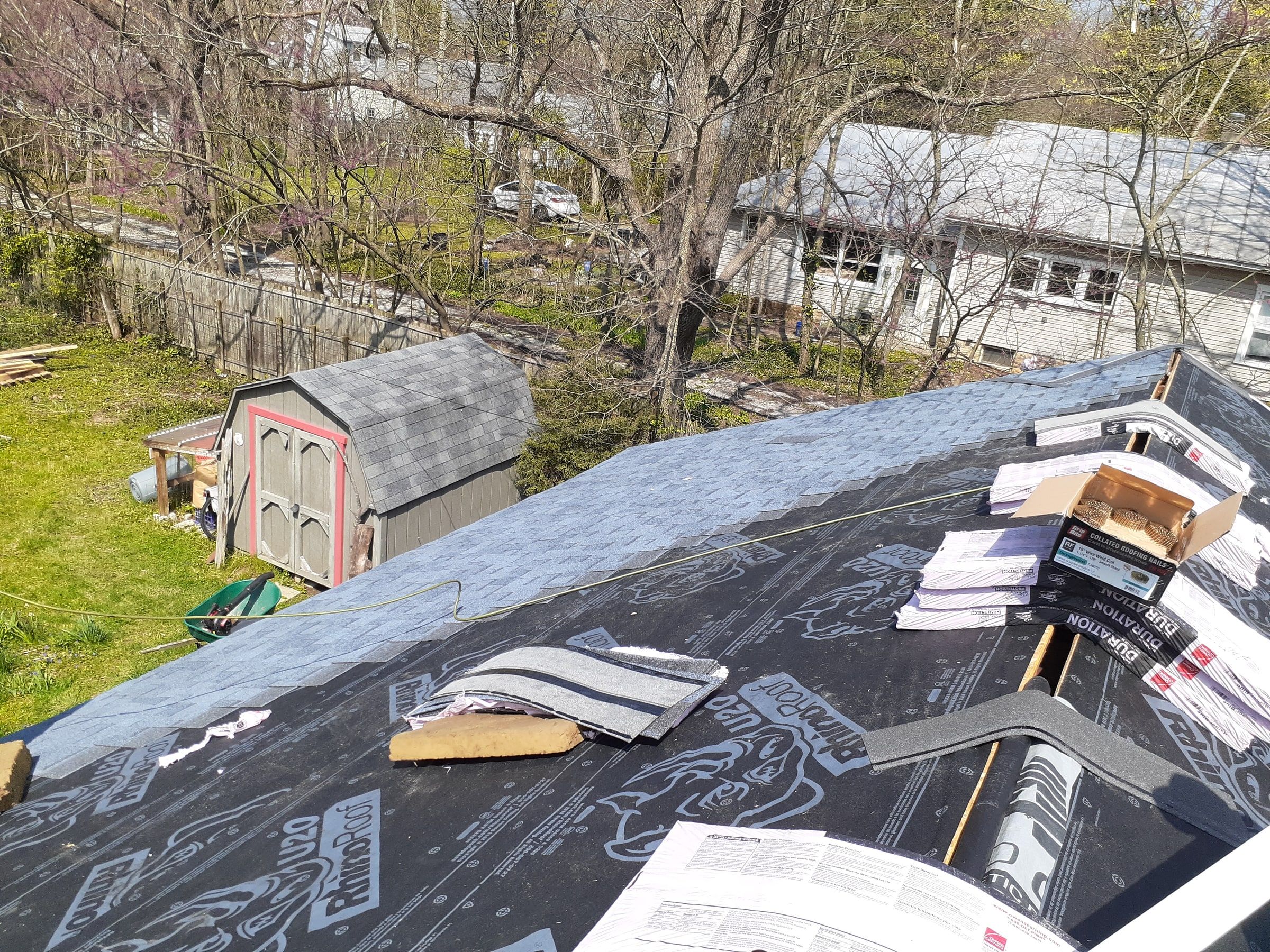 New shingles going on up the slope, with bundles waiting near the ridge, Yellow Springs, Ohio.