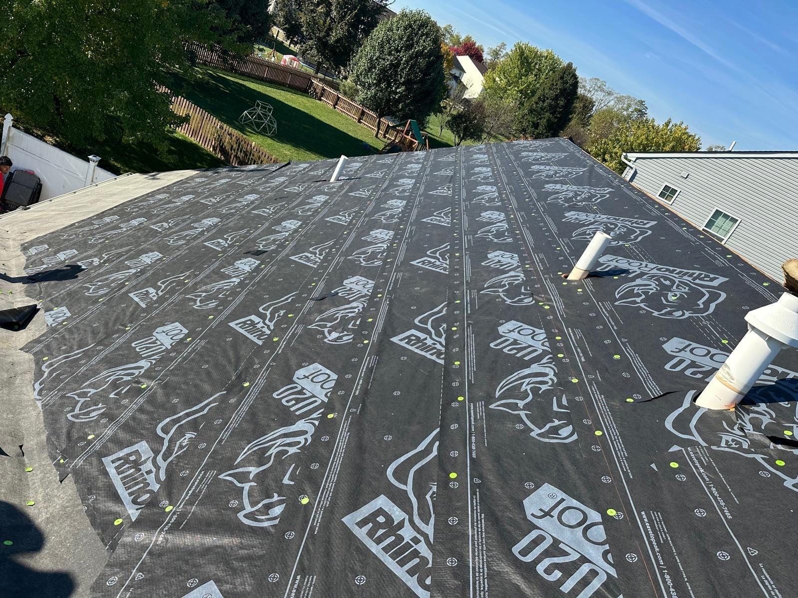 Rows of RhinoRoof underlayment lapped up the slope, ice and water shield at the eave, Beavercreek, Ohio.