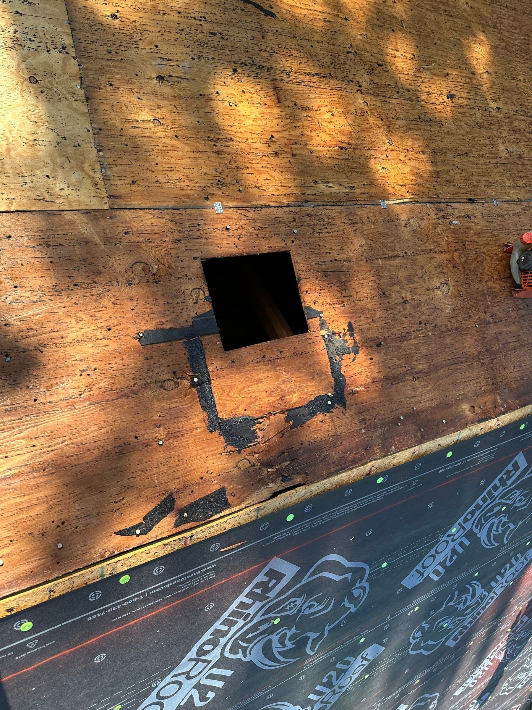 An old vent opening cut in the plywood deck, Beavercreek, Ohio.