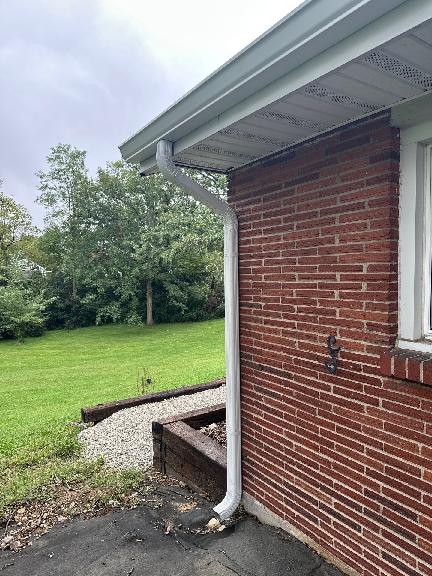 A new downspout at the back brick corner beside the patio, West Carrollton, Ohio.