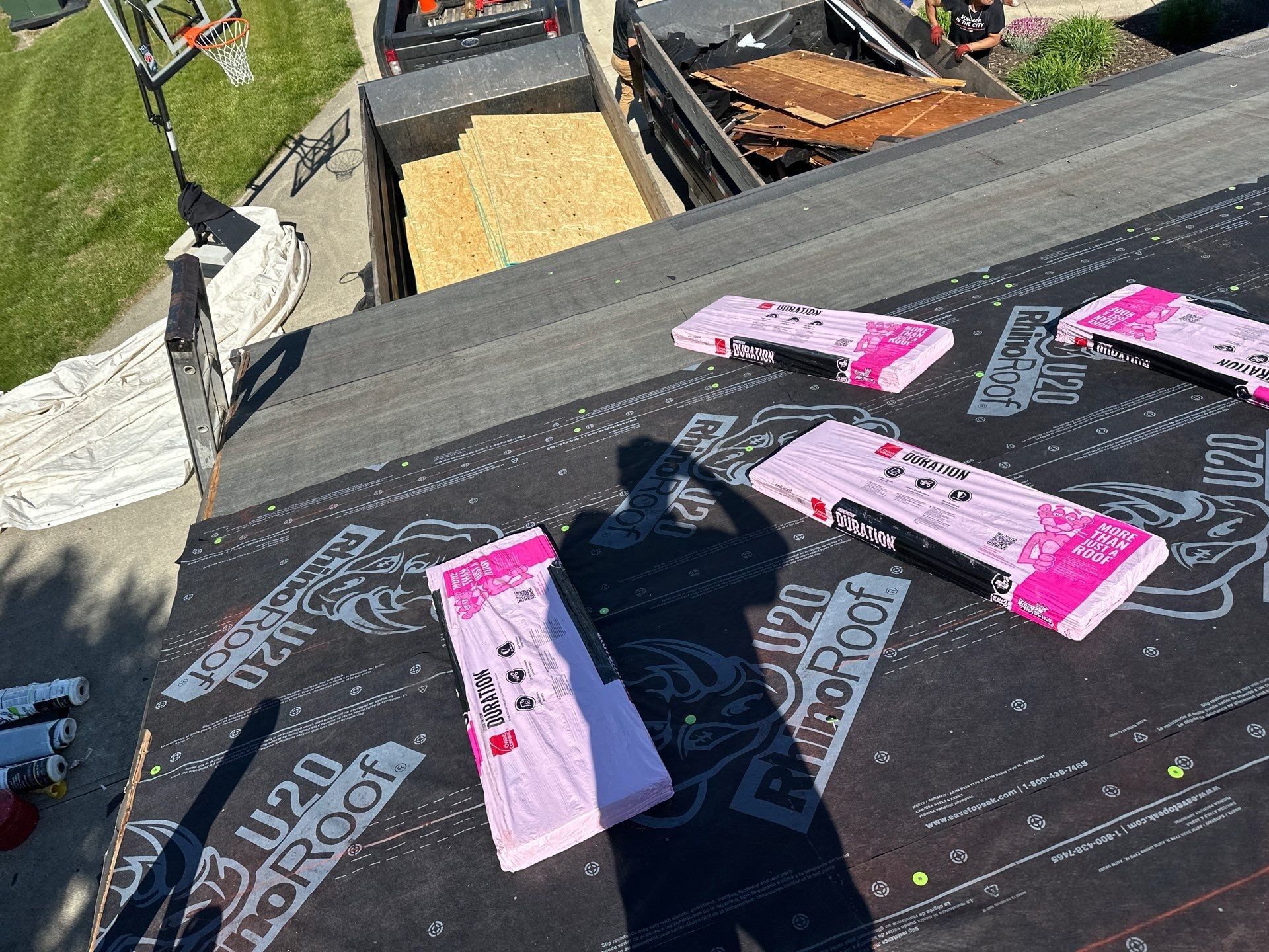 Duration bundles laid out on the underlayment, with the dump trailer below, Beavercreek, Ohio.