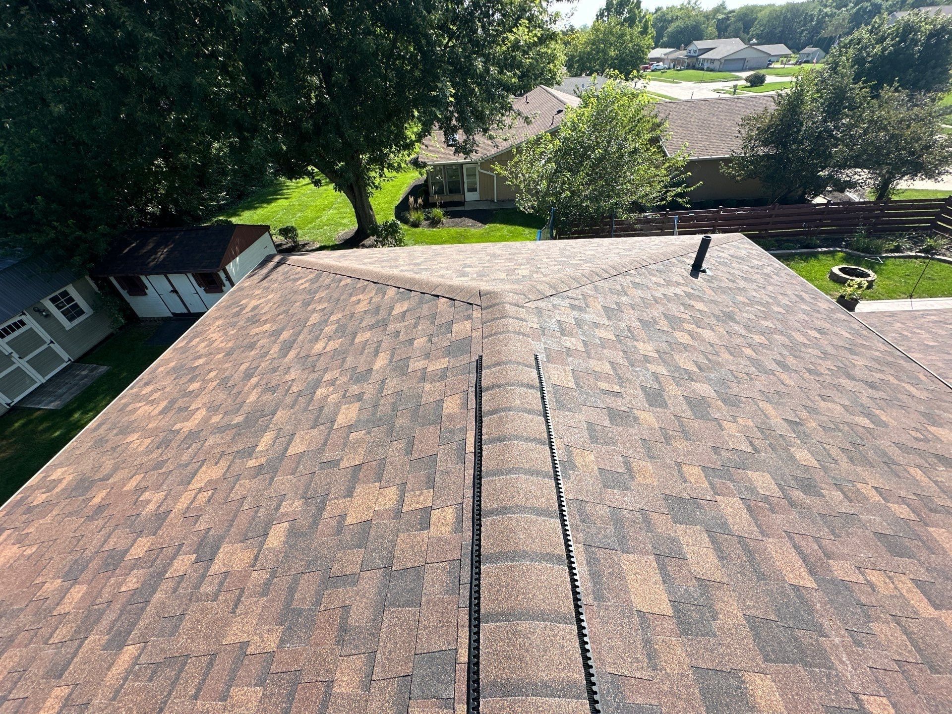 Two finished slopes meeting at a ridge with ridge vent, above the back yard, Dayton, Ohio.