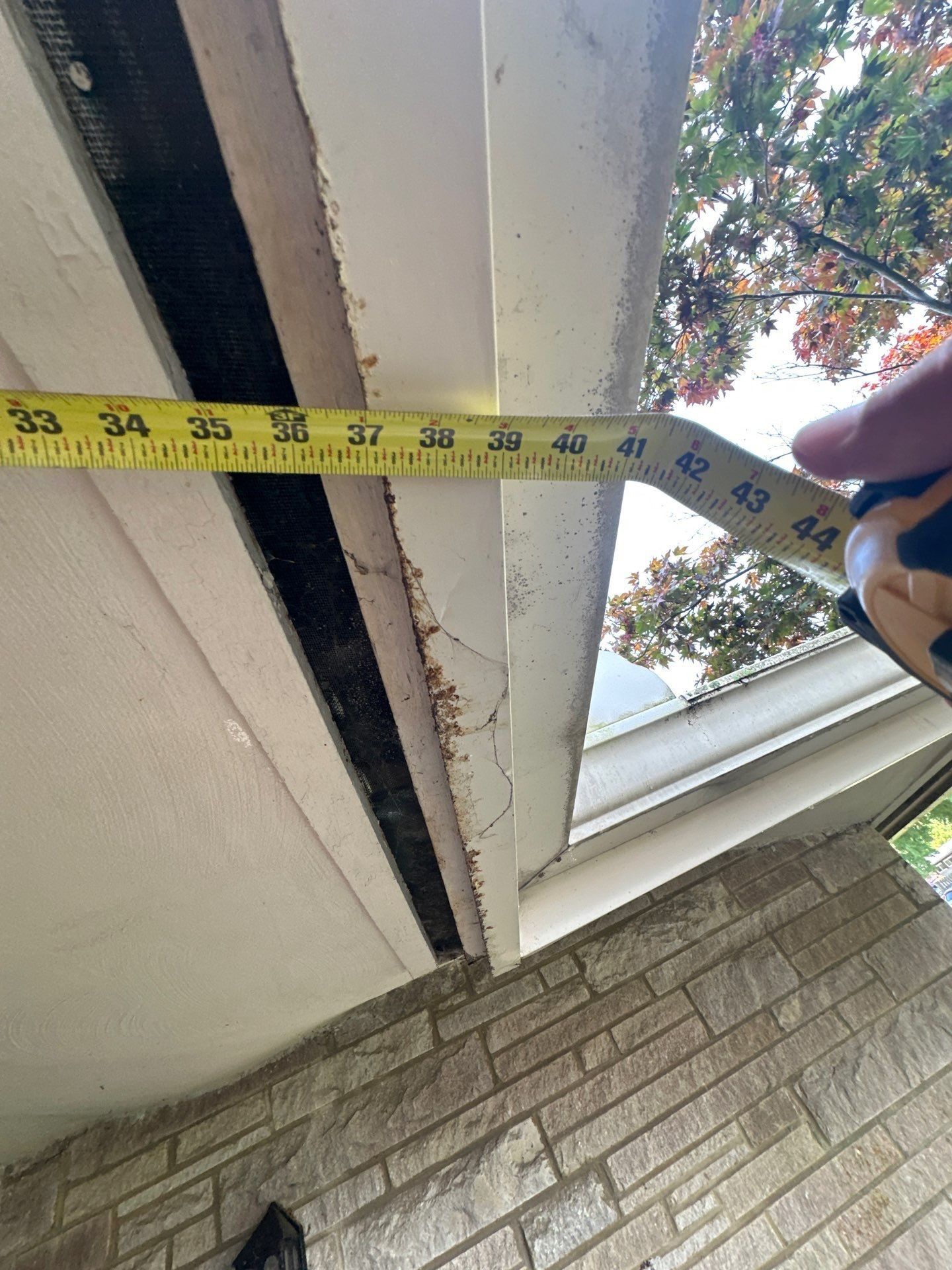 A tape measure across the roof overhang at the eave, Kettering, Ohio.