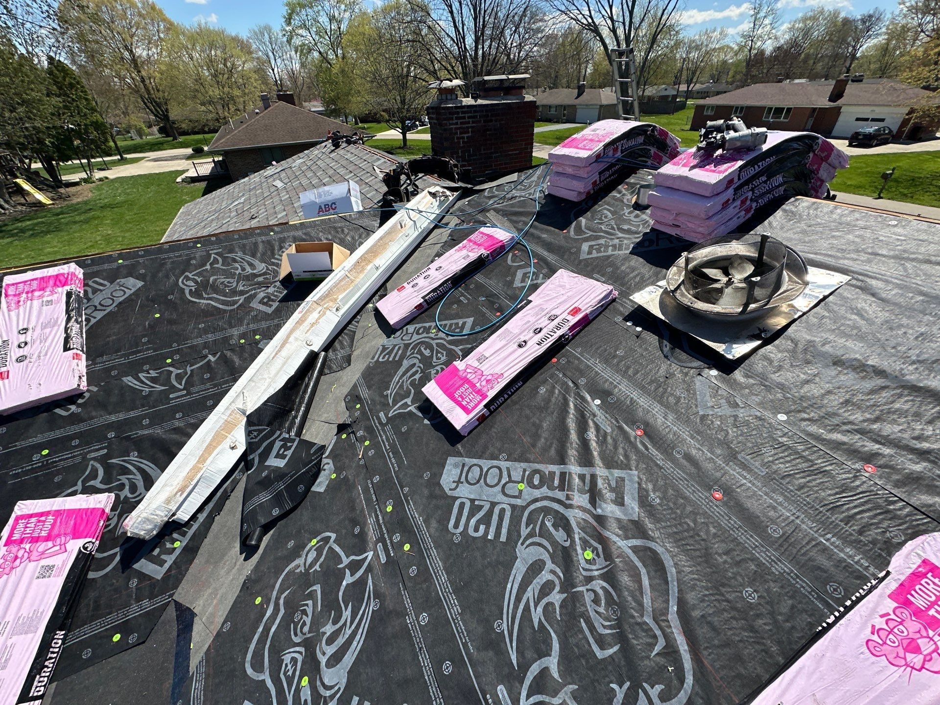 New round roof vent set on its flashing base among shingle bundles, Beavercreek, Ohio.