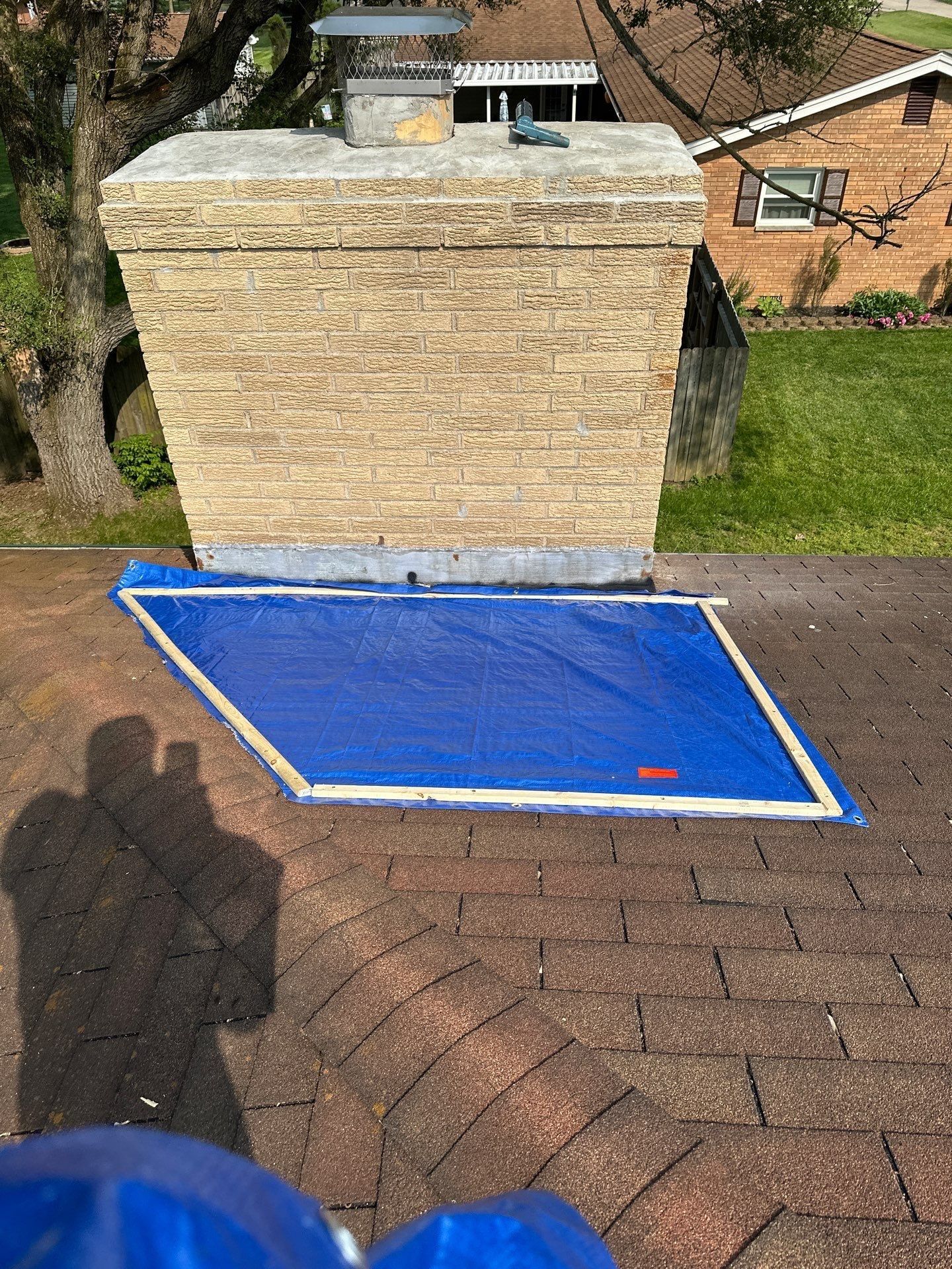 Blue tarp battened tight against the base of the chimney, Beavercreek, Ohio.